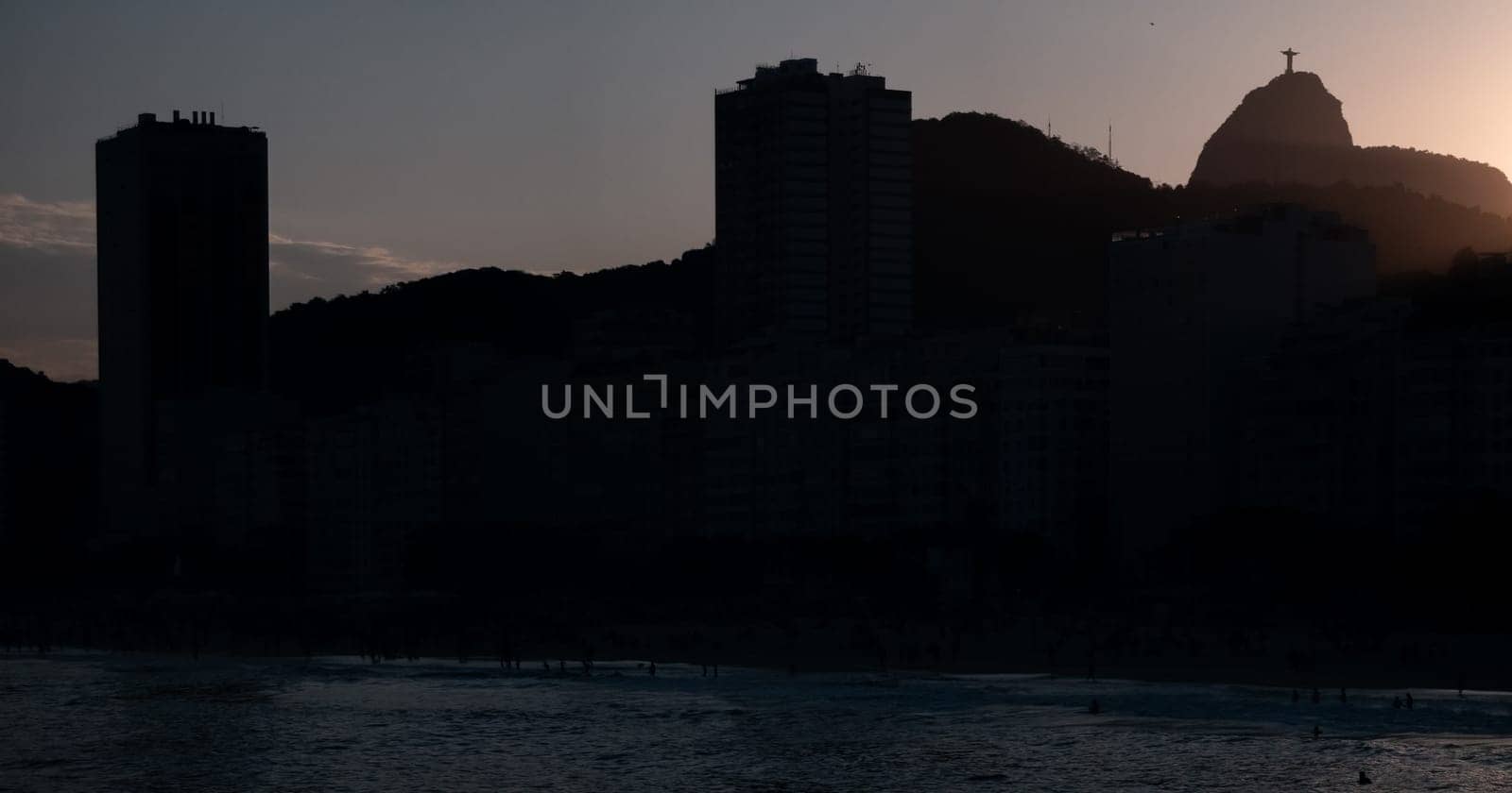 Silhouette of Rio's skyline with the Christ the Redeemer statue at sunset.