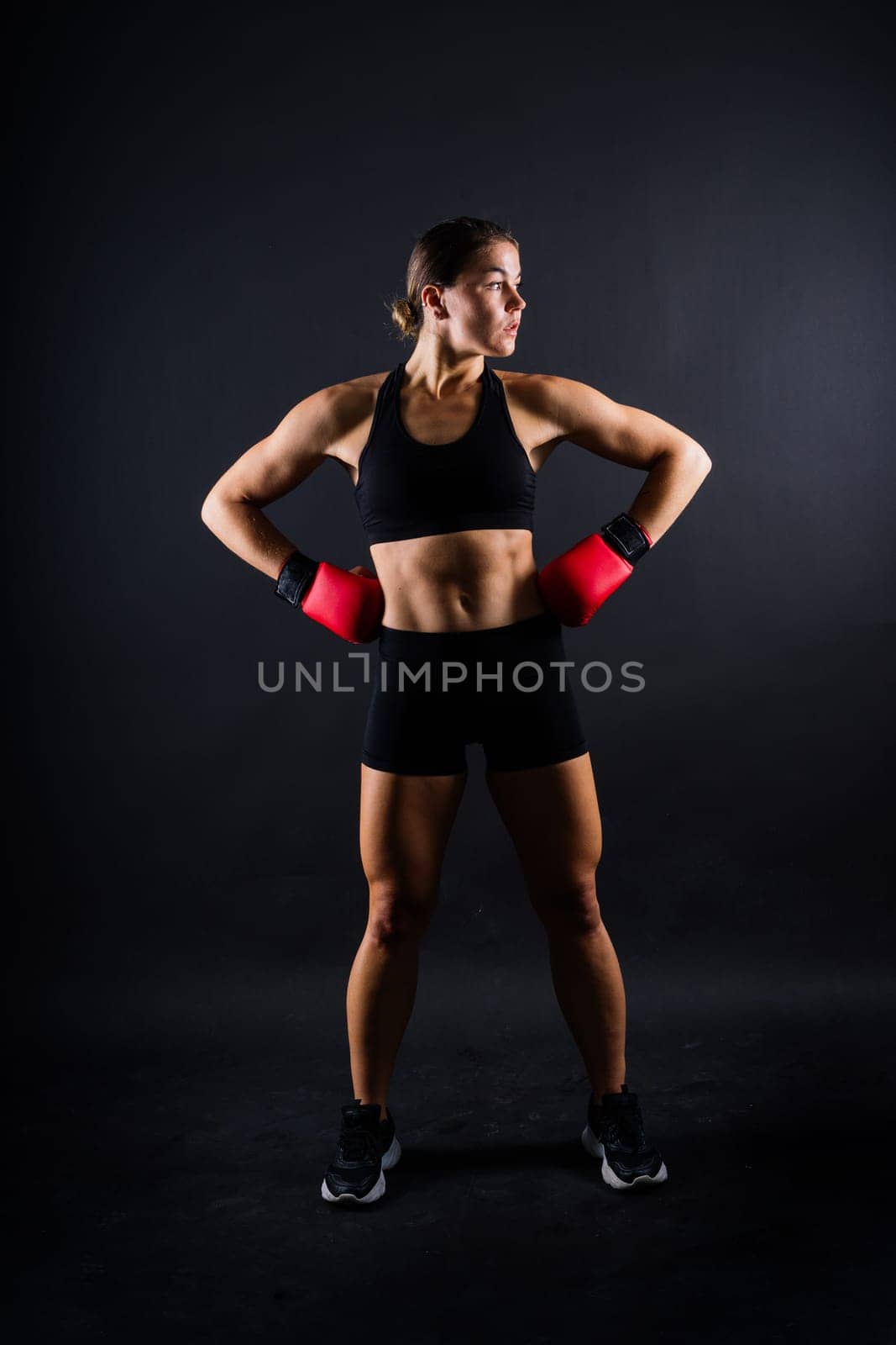 Young woman athletic female MMA fighter is training. Concept of sport, action, healthy lifestyle.