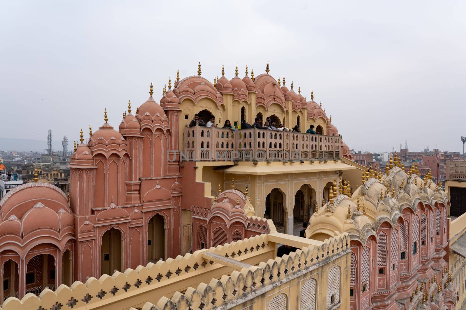 Jaipur, India - December 11, 2019: People at the beautiful Hawa Mahal, Palace of Winds in the pink city.