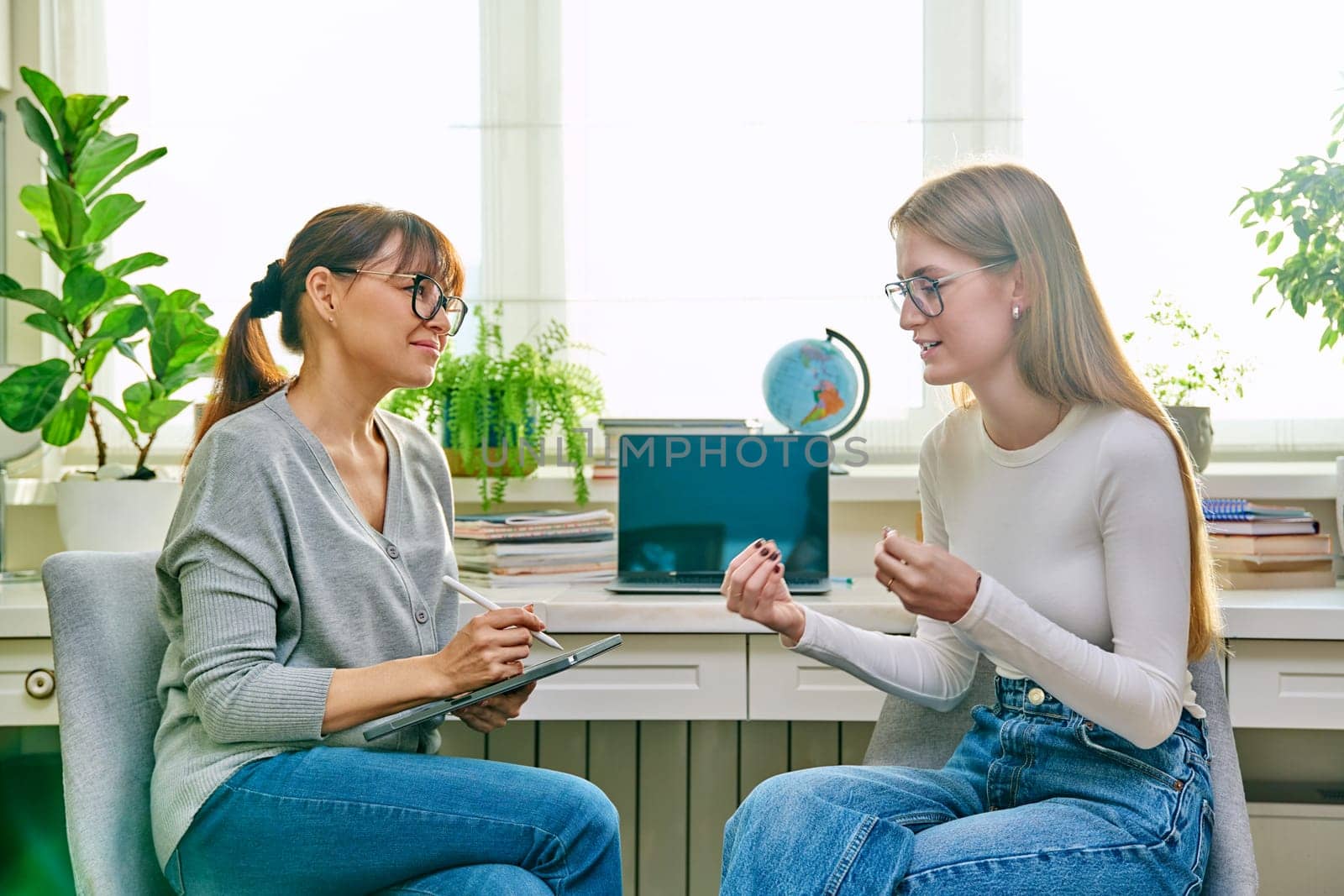Young teenage girl talking with psychologist, therapist by VH-studio