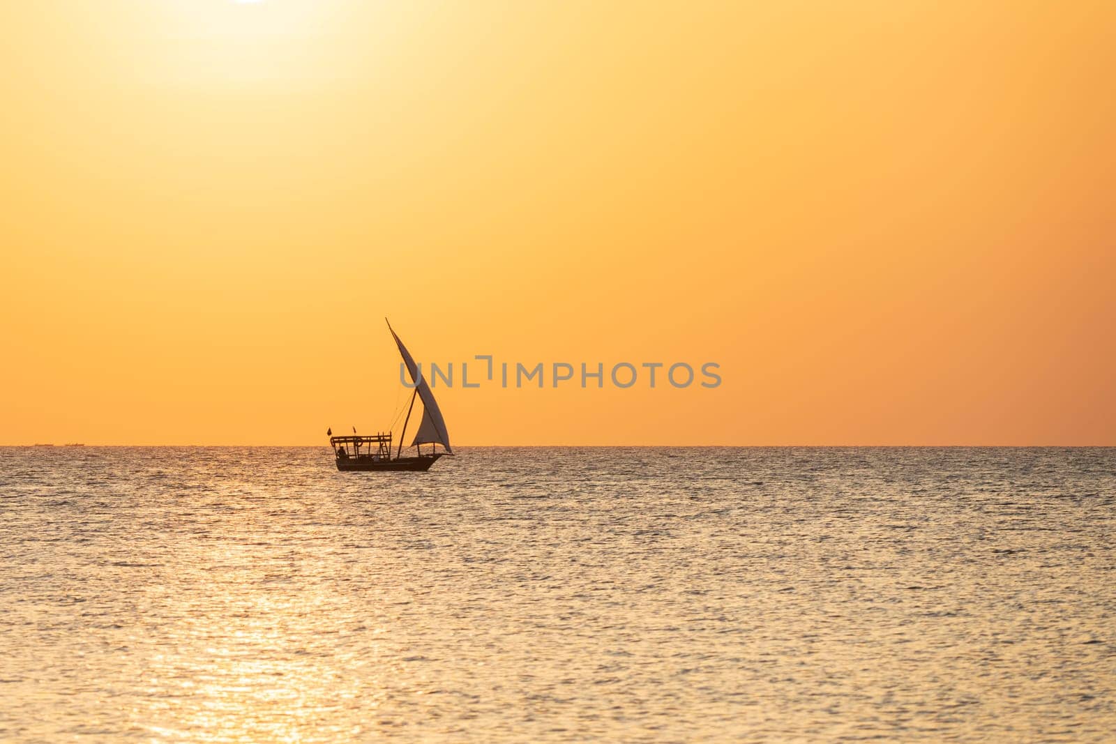 Typical african boat sails in the ocean at sunset by Robertobinetti70