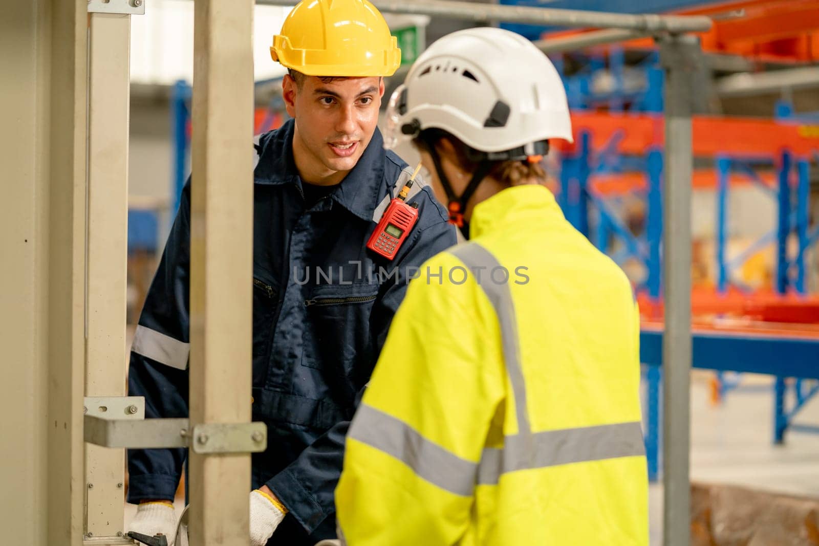 Professional engineer man teach or guide process to control or work with the machine to co-worker woman in workplace area.