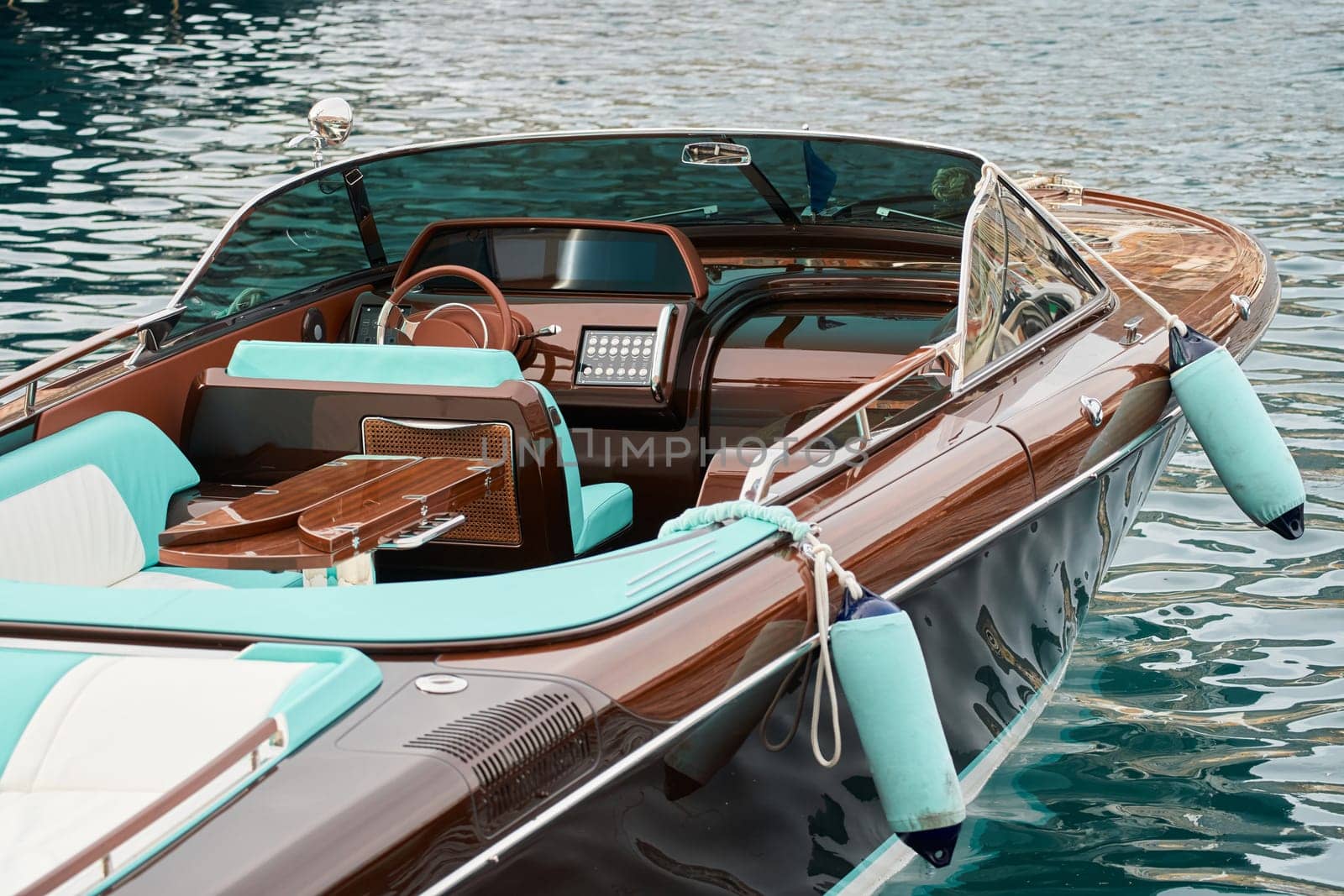 Interior of the luxury motor boat, port of Hercules in Monaco, sunny glare of the sun on the water, powerful boat, glossy surfaces shine in sunny weather by vladimirdrozdin