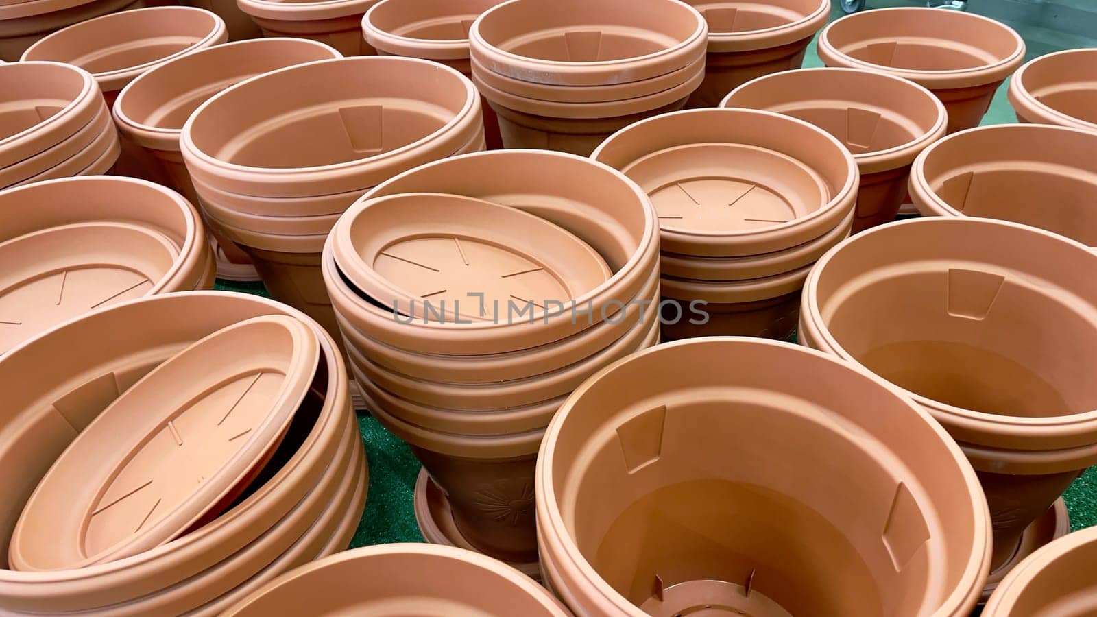 Close-up of empty flower pots in a store or greenhouse. Colorful pots for plants. Gardening and landscape design concept by Matiunina
