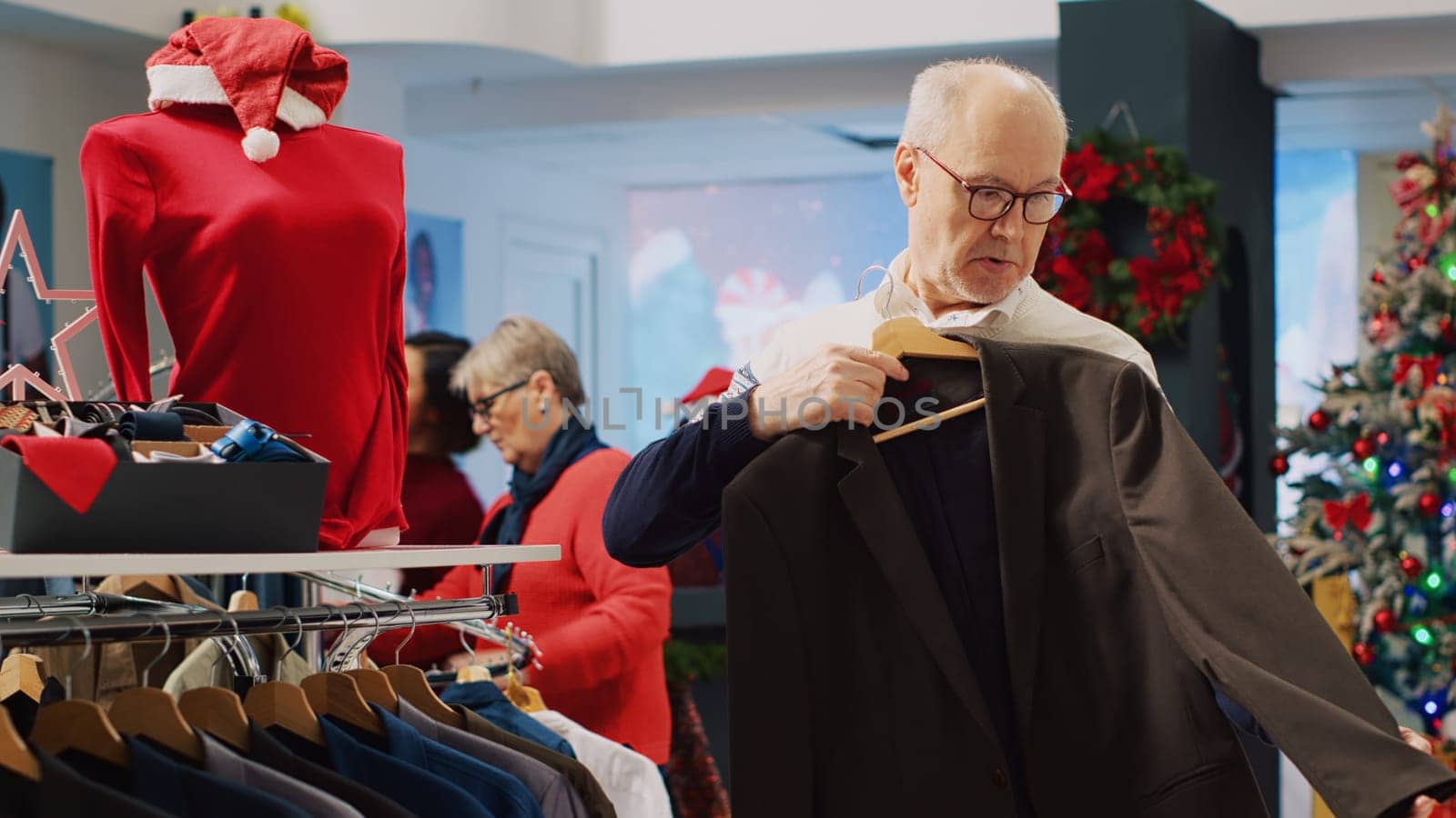 Senior man browsing blazers by DCStudio