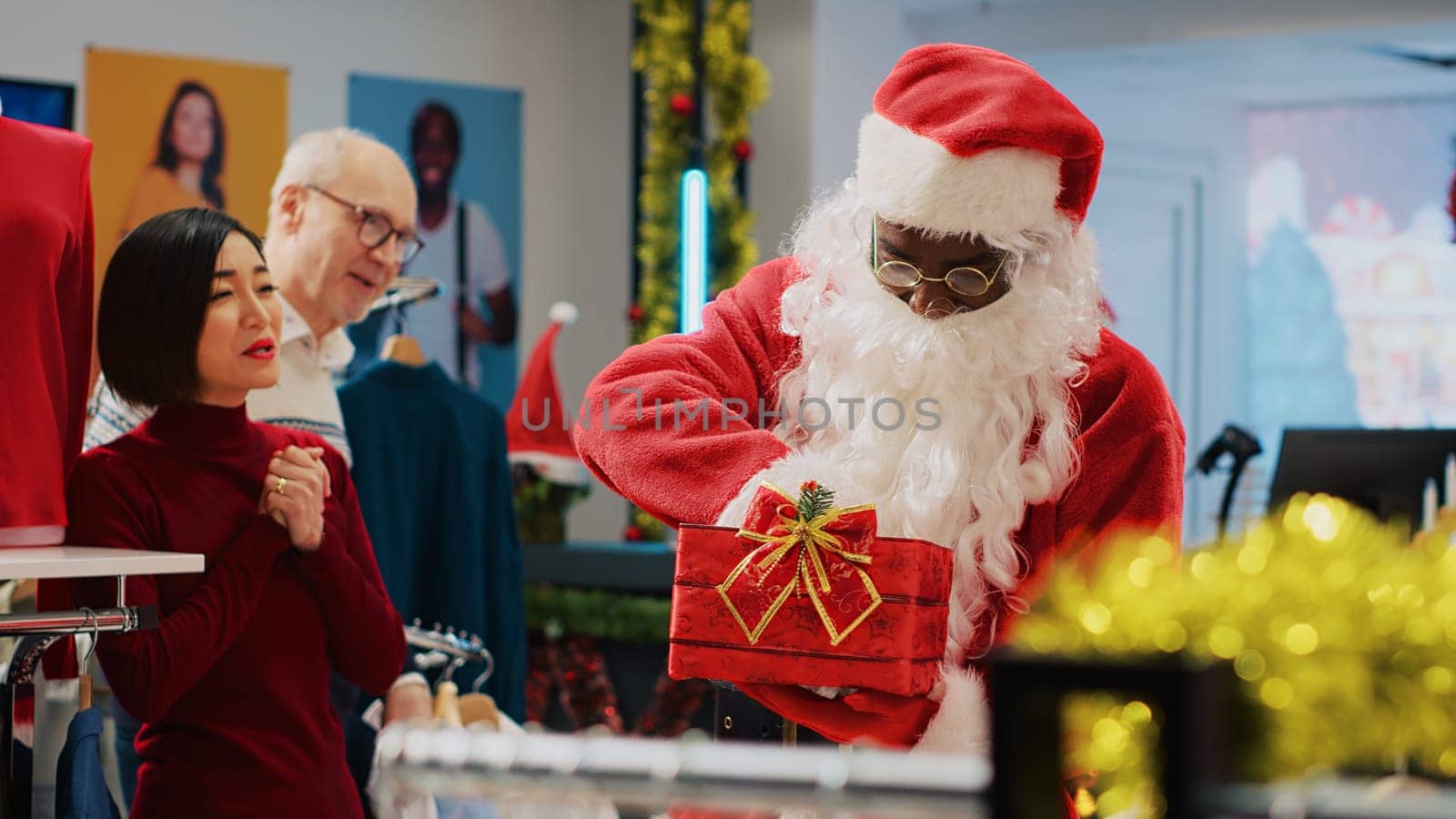 Worker wearing Santa Claus outfit in xmas ornate clothing store, inviting customers to participate in Christmas raffle competition in order to win promotional prize during festive holiday season
