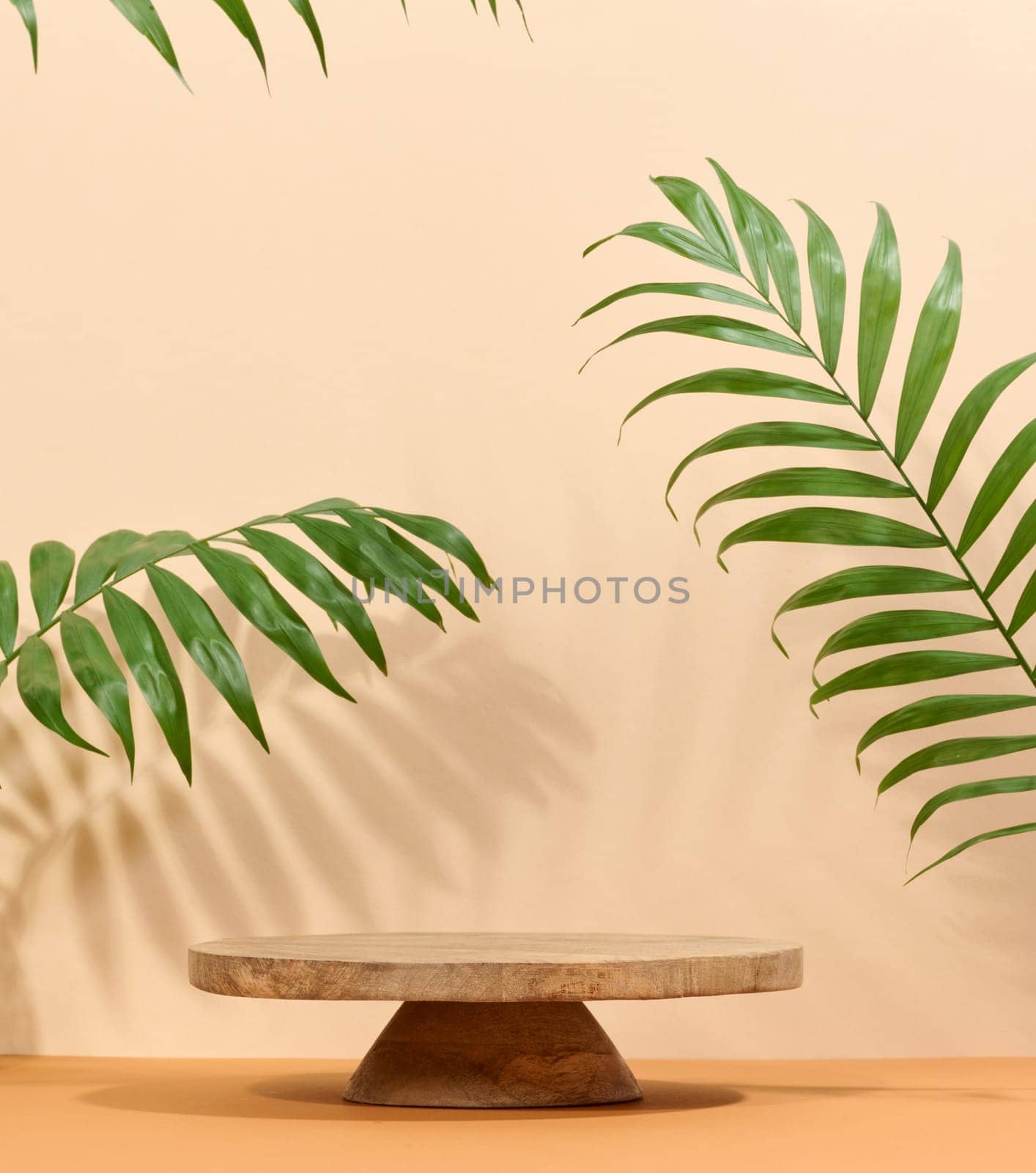 Round brown wooden stand on a white background, a place to display cosmetics and products