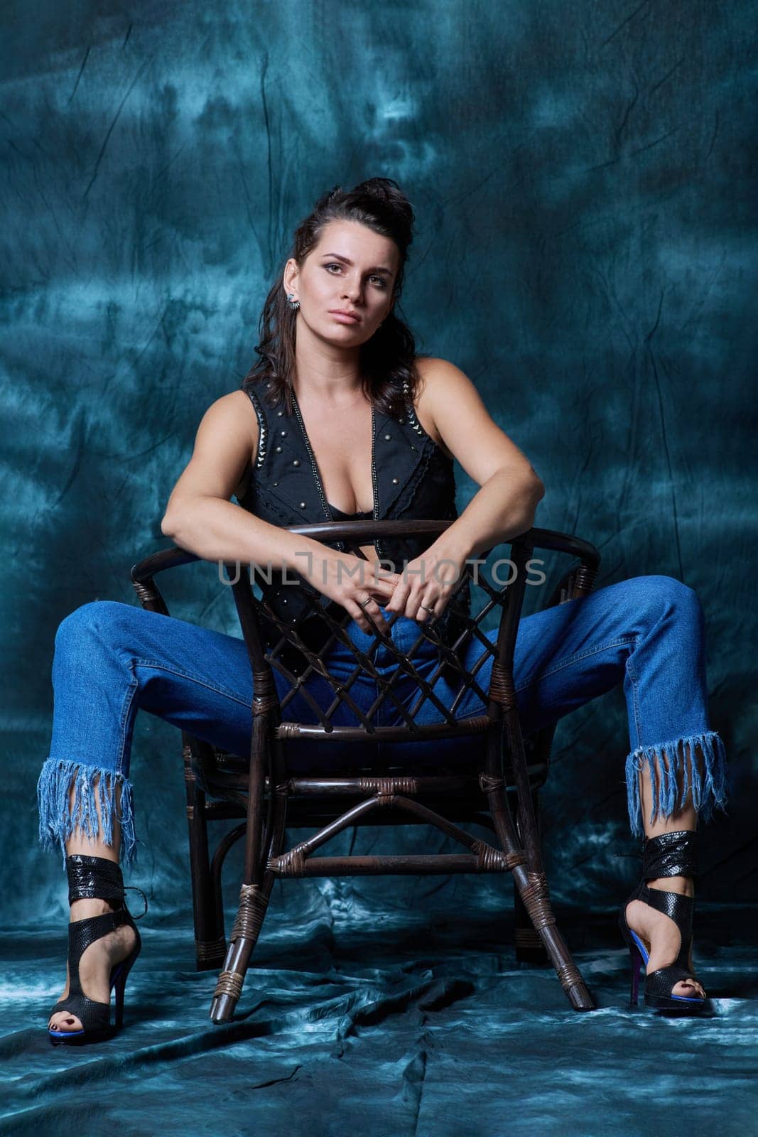 Young trendy woman posing in the studio in denim style. Fashion, style, clothing, trends concept