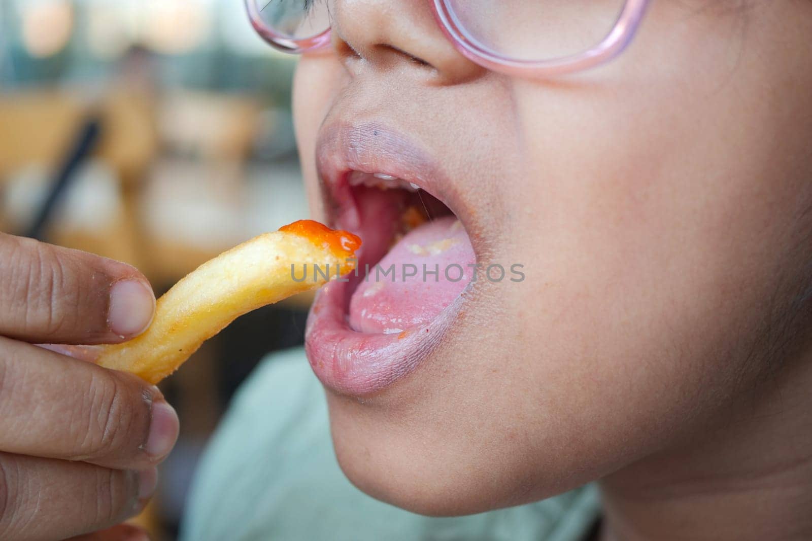 child eating french fries close up by towfiq007