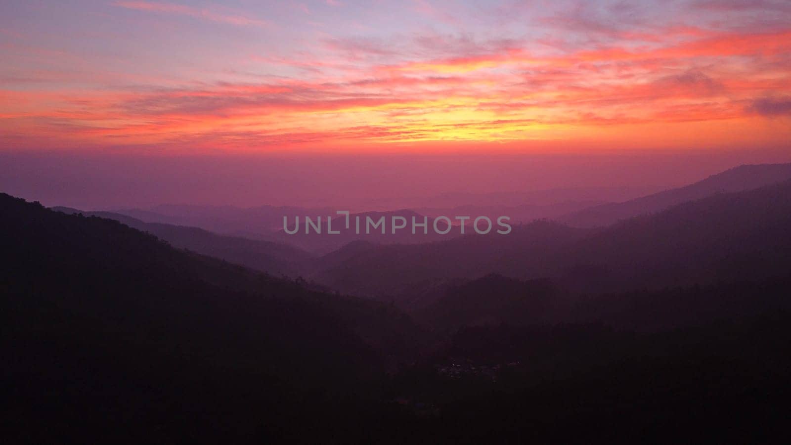 Beautiful nature morning with orange, yellow sunshine and fluffy clouds. Beautiful colorful dramatic sky with clouds at sunset or sunrise. by TEERASAK