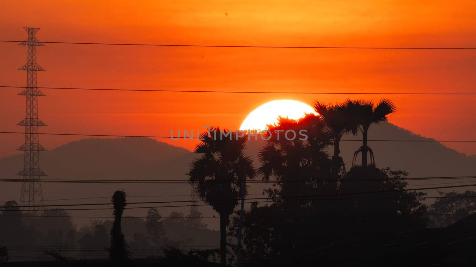 Beautiful nature morning with orange, yellow sunshine and fluffy clouds. Beautiful colorful dramatic sky with clouds at sunset or sunrise. by TEERASAK