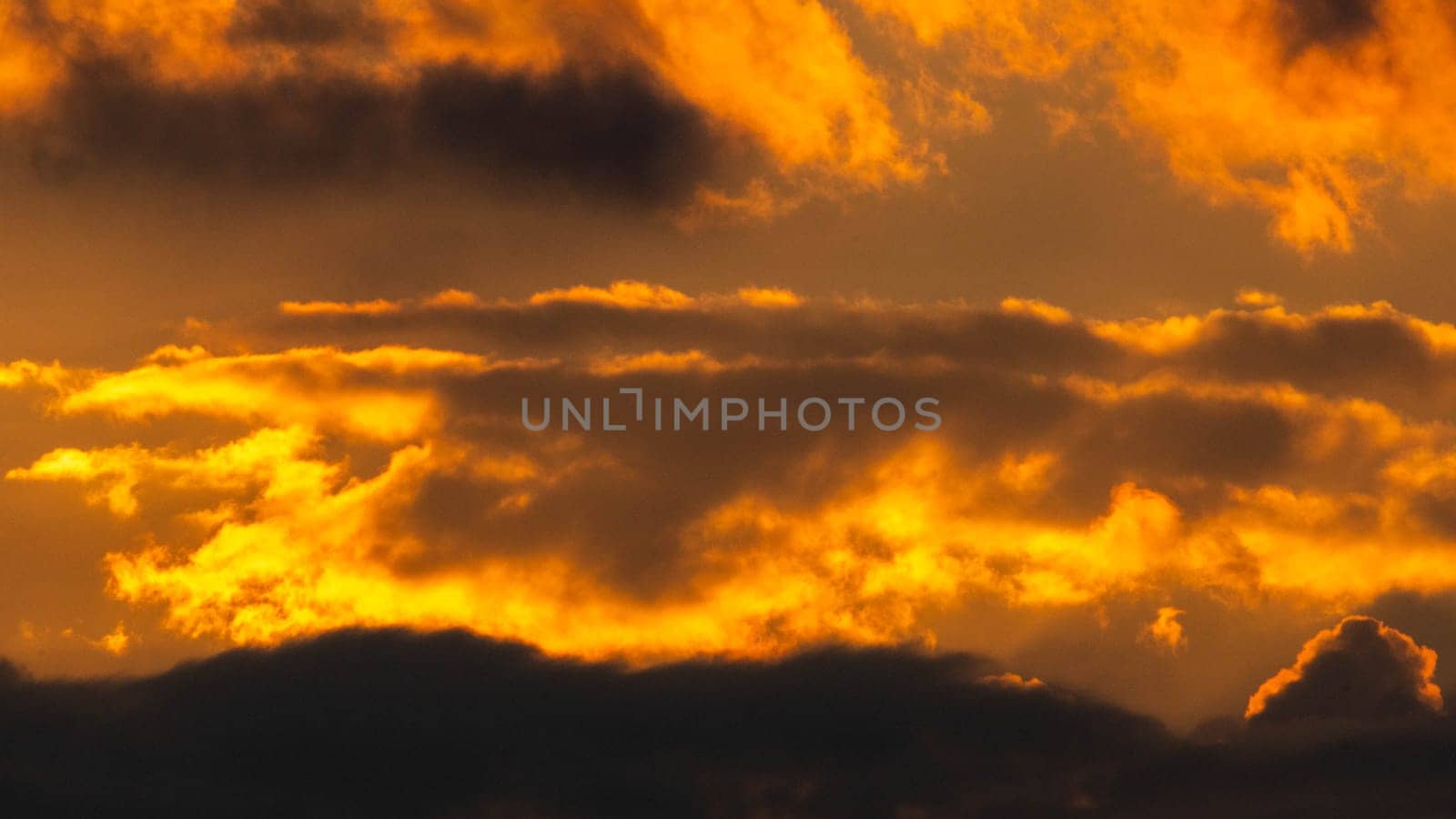 Beautiful nature morning with orange, yellow sunshine and fluffy clouds. Beautiful colorful dramatic sky with clouds at sunset or sunrise. by TEERASAK