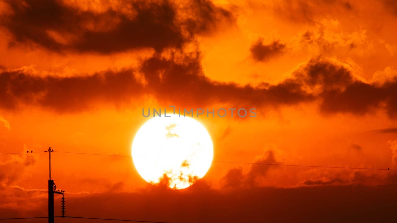 Beautiful nature morning with orange, yellow sunshine and fluffy clouds. Time lapse of a beautiful dramatic sky with a big sun at sunrise. by TEERASAK