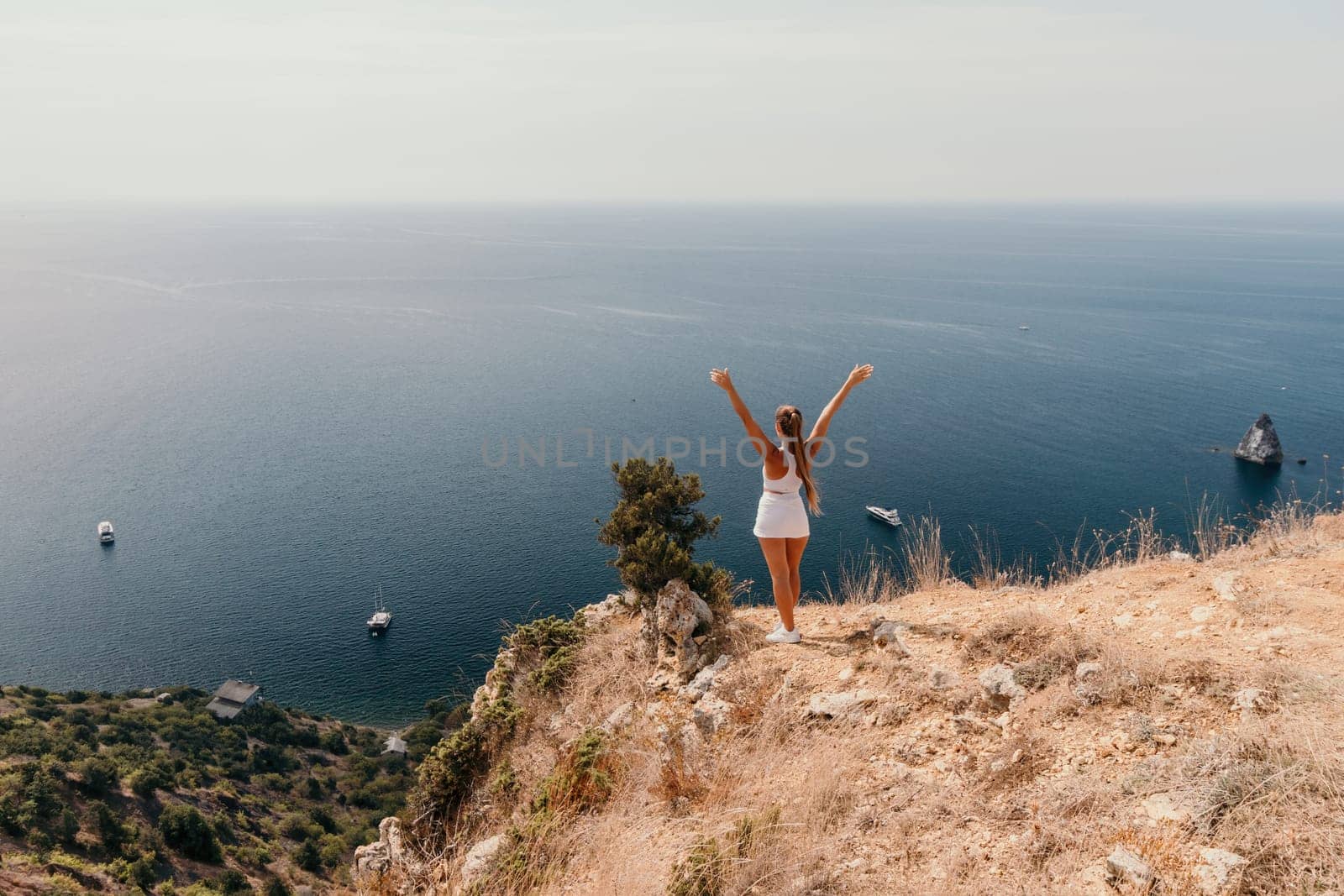 Woman sea pilates. Sporty middle-aged woman training in pilates on yoga mat by sea. concepts of health, wellness, and mindfulness in exercise, promoting the benefits of active and balanced lifestyle by panophotograph