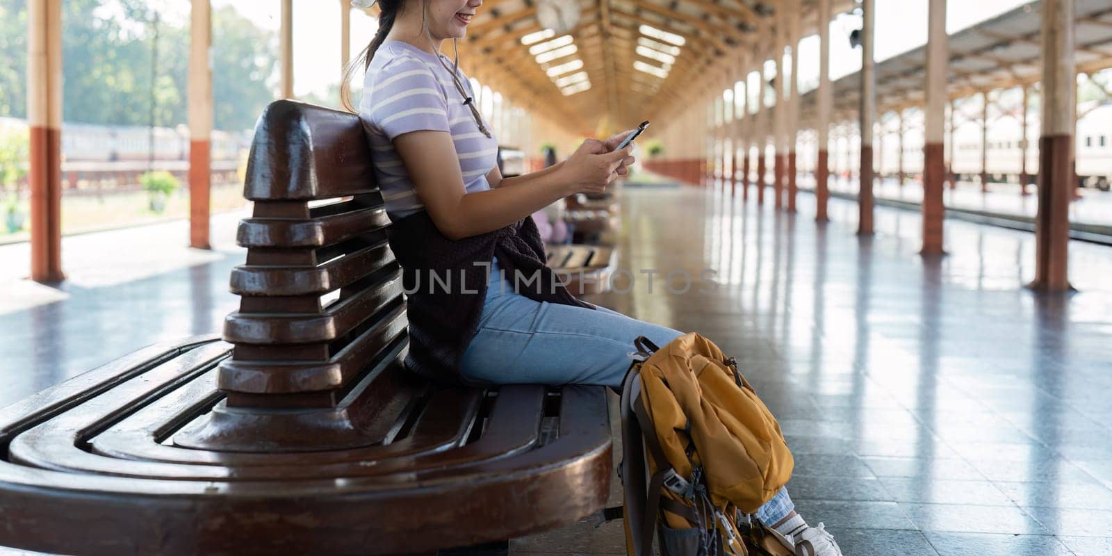 Woman using mobile phone while travel by train. travel concept.