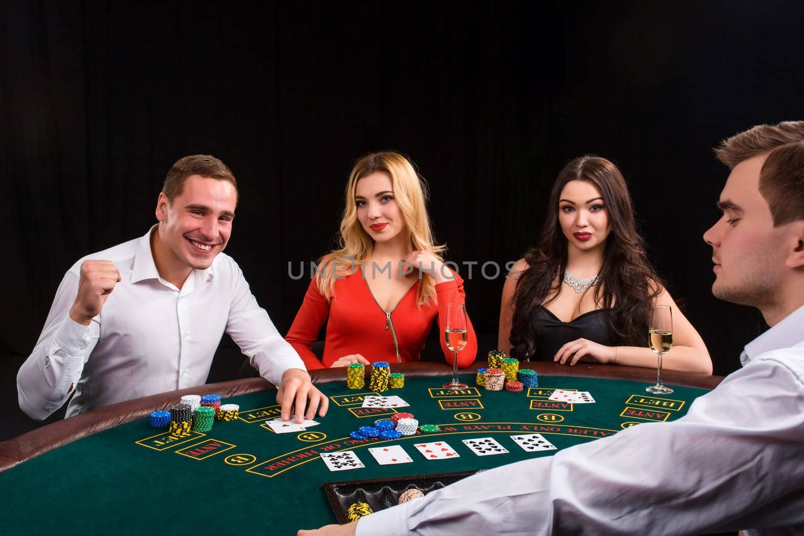 Friends enjoying a gambling night. The dealer deals the cards by nazarovsergey