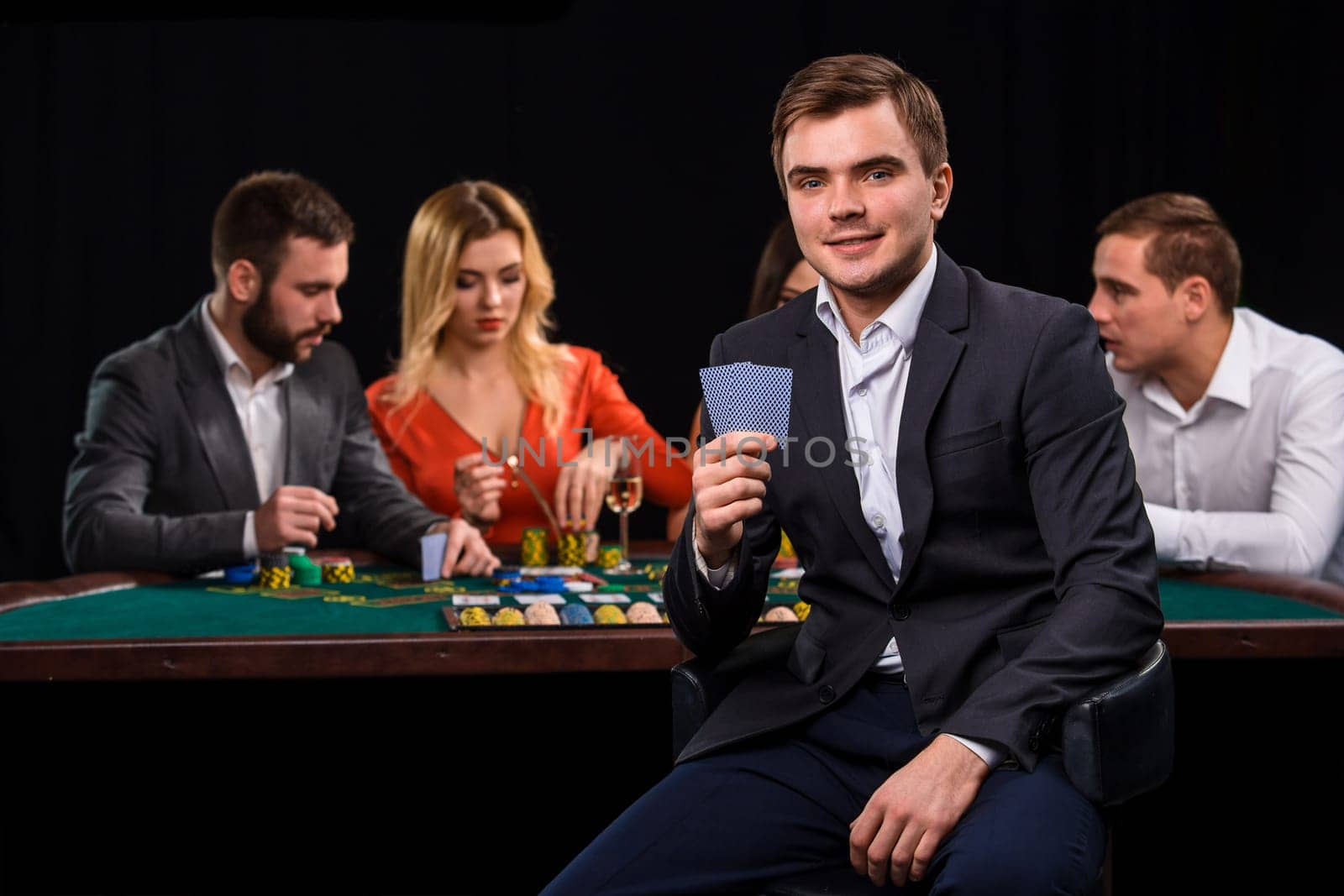Young people playing poker at the table. Casino by nazarovsergey