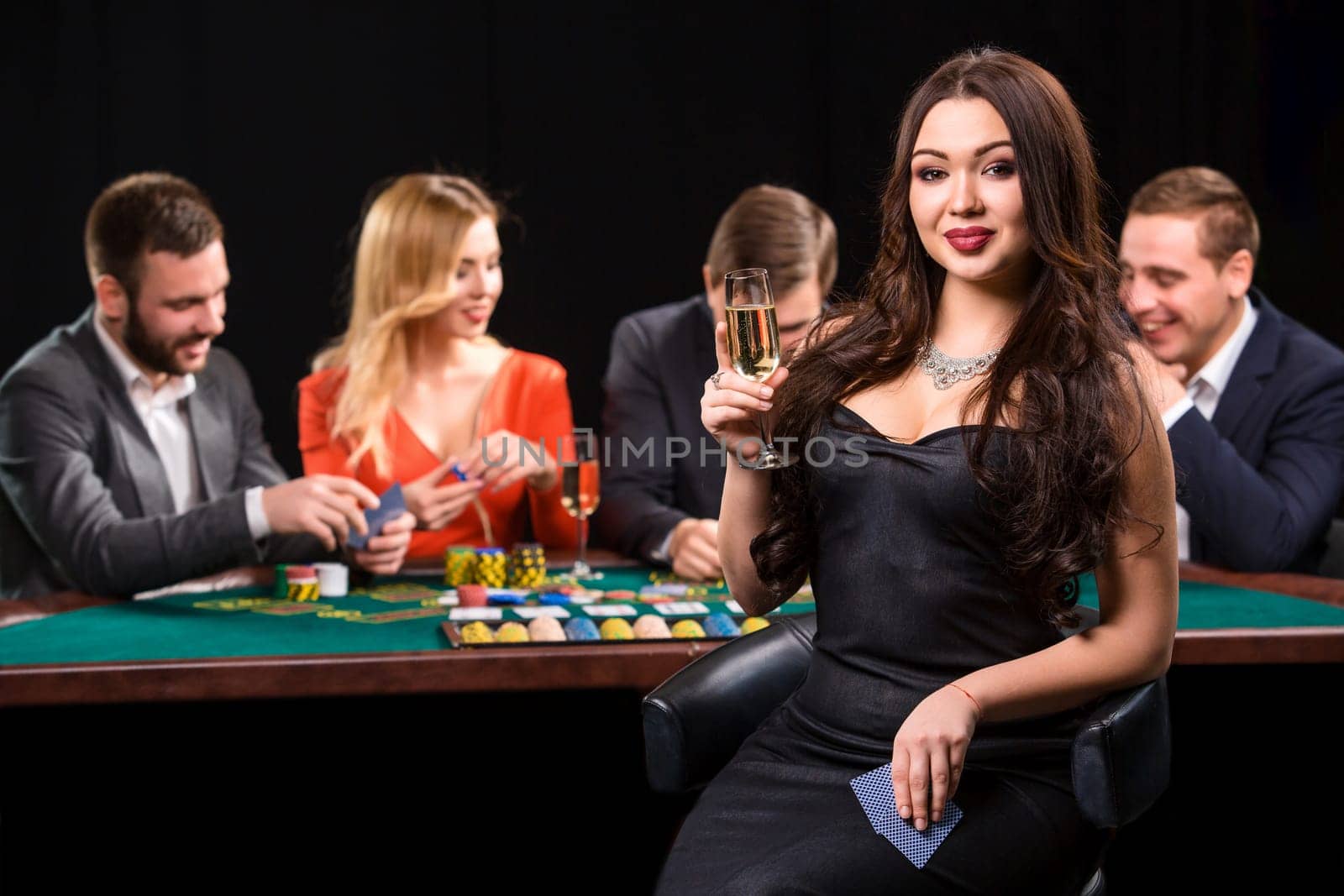 Young people playing poker at the table. Casino by nazarovsergey