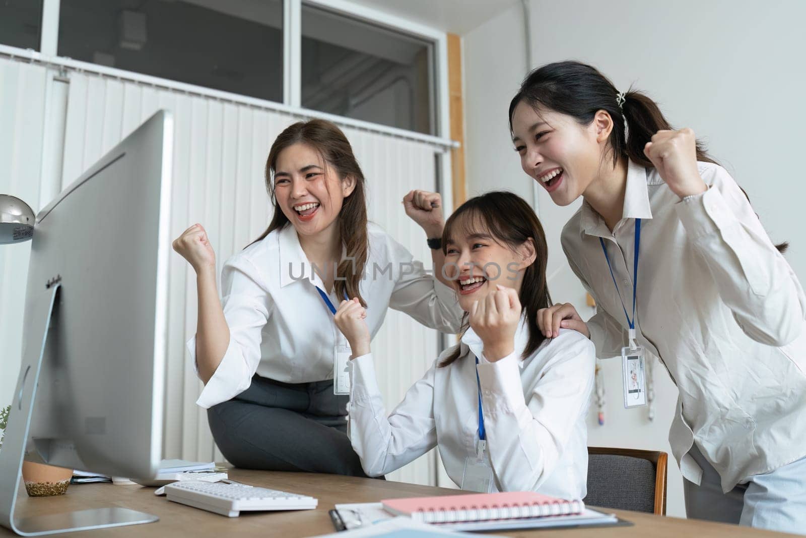 Cheerful group of motivated successful multiracial business people, working together on a project in a modern office.