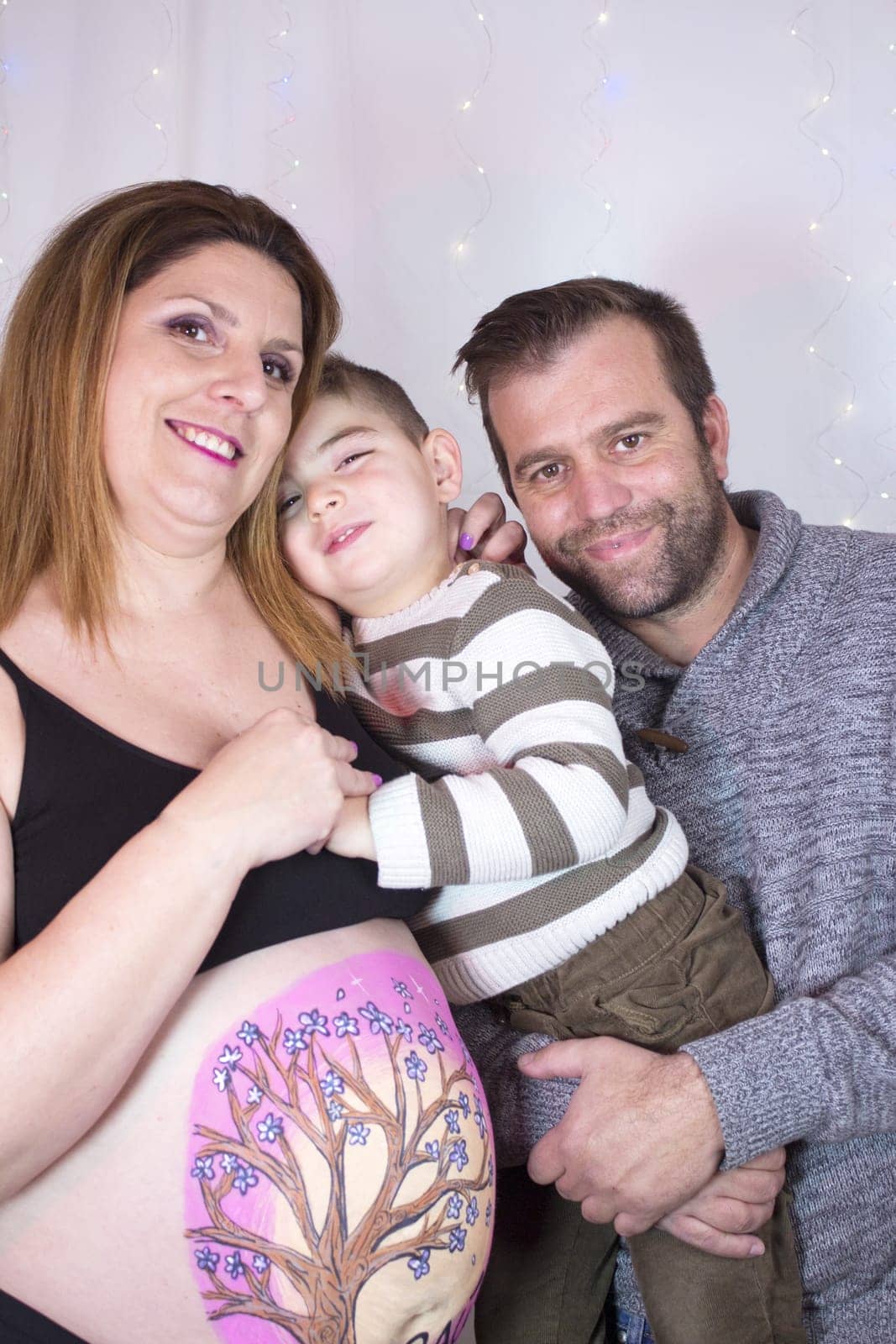 Family scene with pregnant mother, father and little son. No copy space