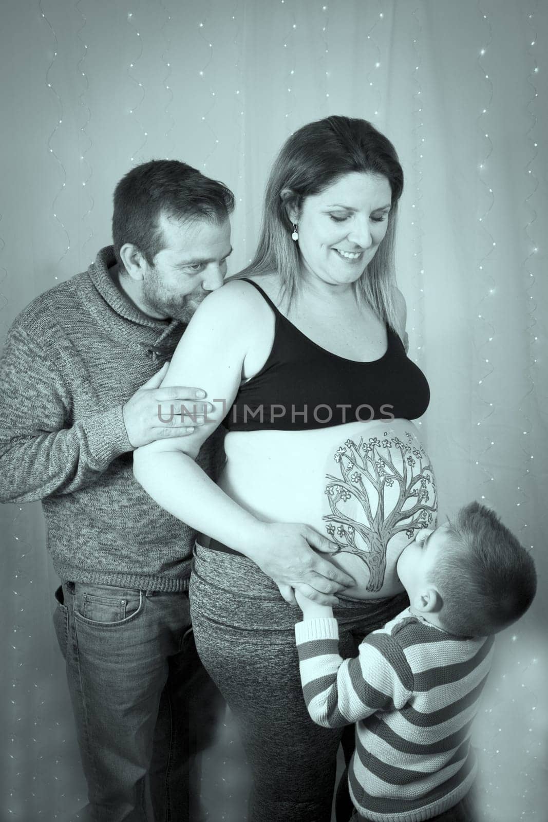 Family scene with pregnant mother, father and little son. No copy space