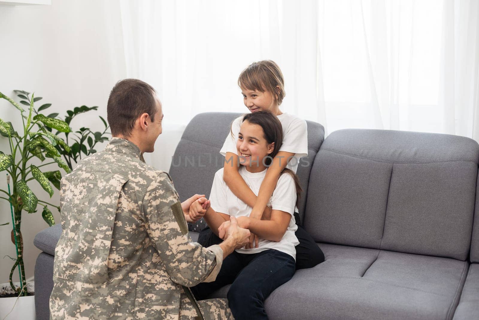 Soldier with his little children at home. High quality photo