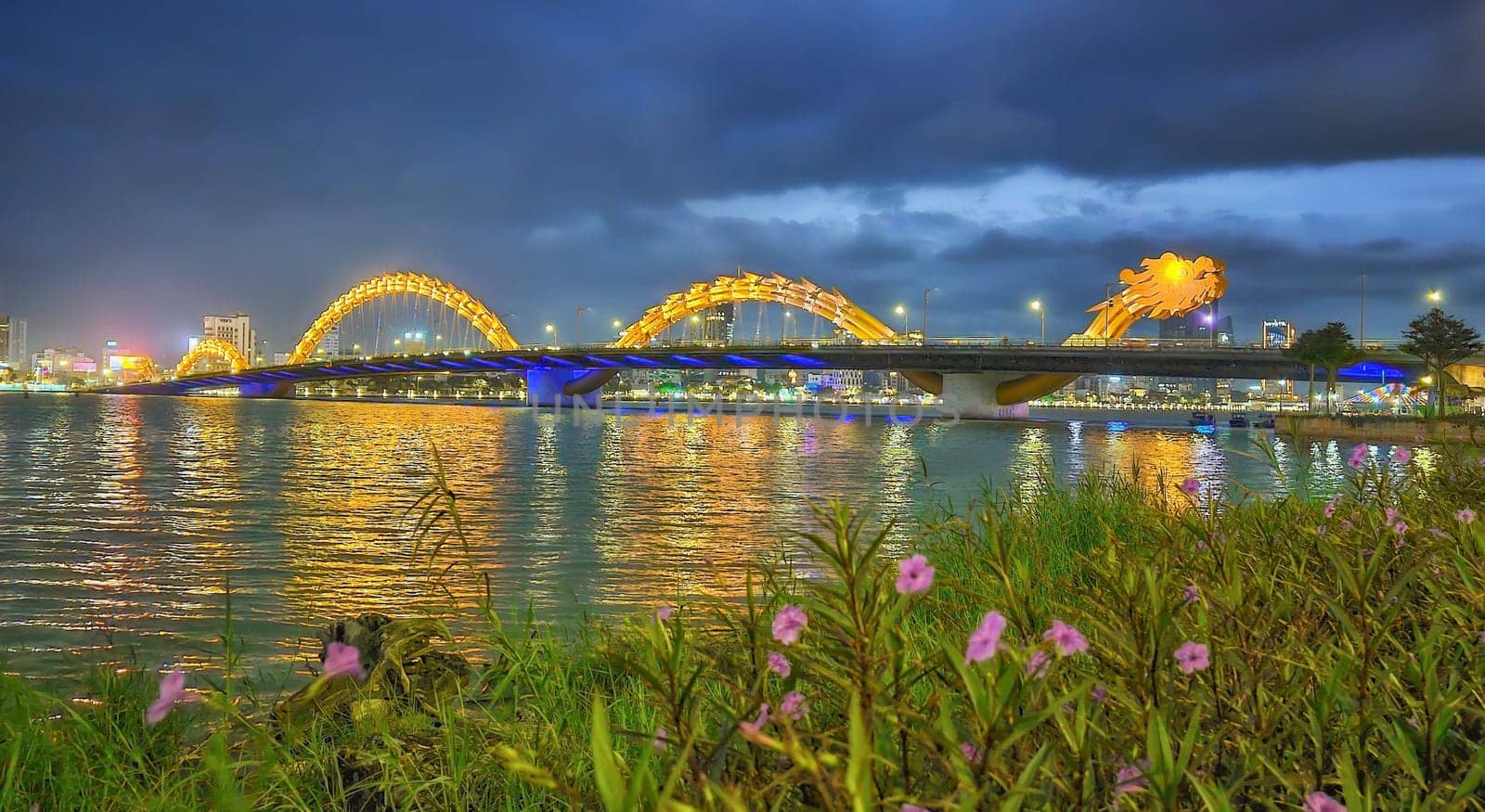 Famous colorful dragon bridge over river Han in Da Nang by night, Vietnam
