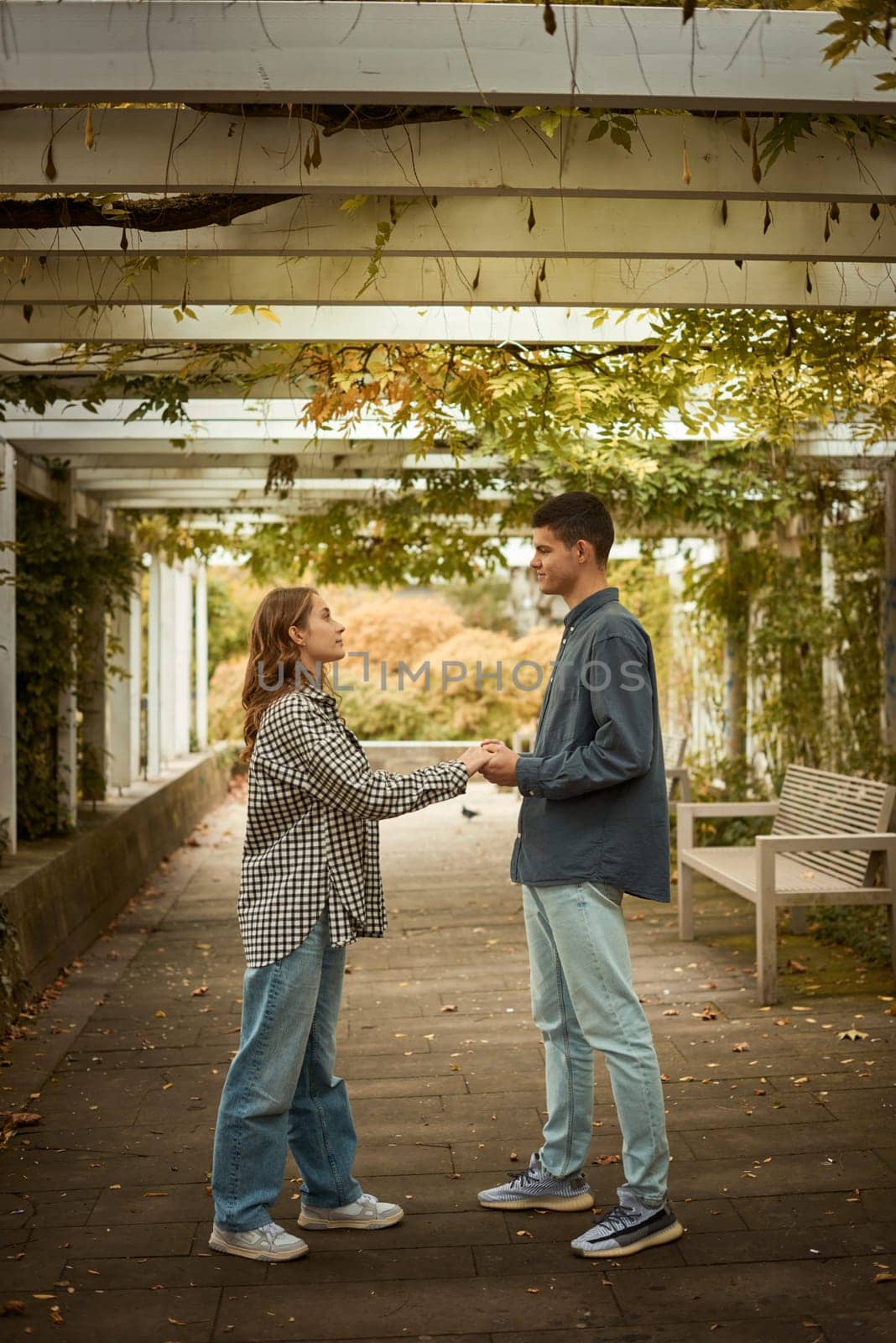 Young Cute Female Hugs Boyfriend. In Autumn Outdoor. Lovers Walking in Park. Attractive Funny Couple. Lovestory in Forest. Man and Woman. Cute Lovers in the Park. Family Concept. Happy Couple.