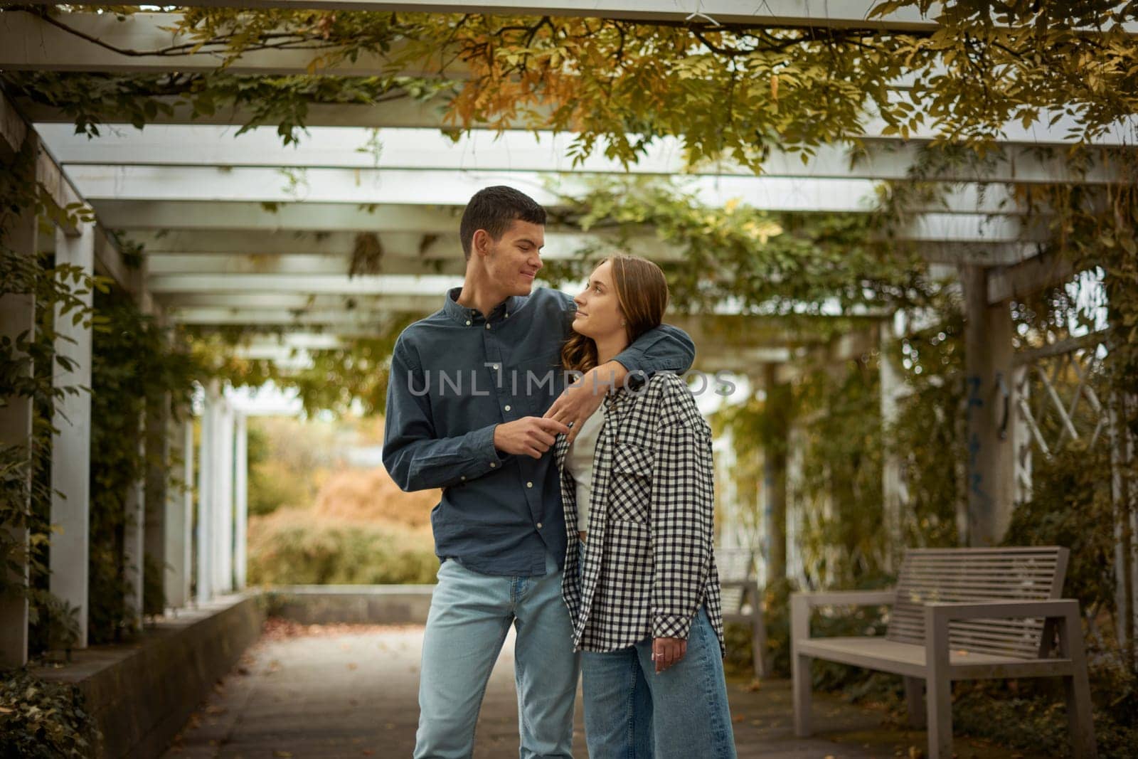 Young Cute Female Hugs Boyfriend. In Autumn Outdoor. Lovers Walking in Park. Attractive Funny Couple. Lovestory in Forest. Man and Woman. Cute Lovers in the Park. Family Concept. Happy Couple.