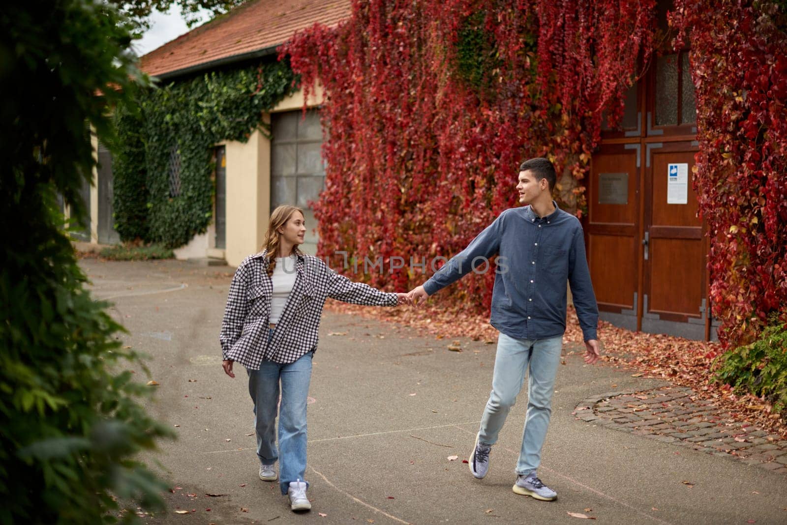 Young Cute Female Hugs Boyfriend. In Autumn Outdoor. Lovers Walking in Park. Attractive Funny Couple. Lovestory in Forest. Man and Woman. Cute Lovers in the Park. Family Concept. Happy Couple.