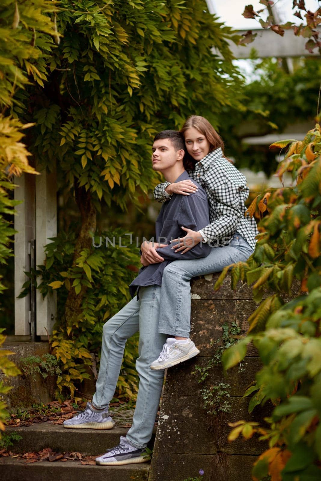 Young Cute Female Hugs Boyfriend. In Autumn Outdoor. Lovers Walking in Park. Attractive Funny Couple. Lovestory in Forest. Man and Woman. Cute Lovers in the Park. Family Concept. Happy Couple. by Andrii_Ko