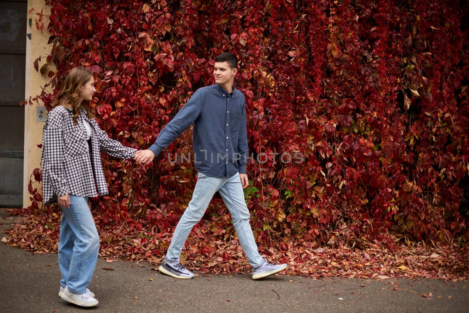 Young Cute Female Hugs Boyfriend. In Autumn Outdoor. Lovers Walking in Park. Attractive Funny Couple. Lovestory in Forest. Man and Woman. Cute Lovers in the Park. Family Concept. Happy Couple.