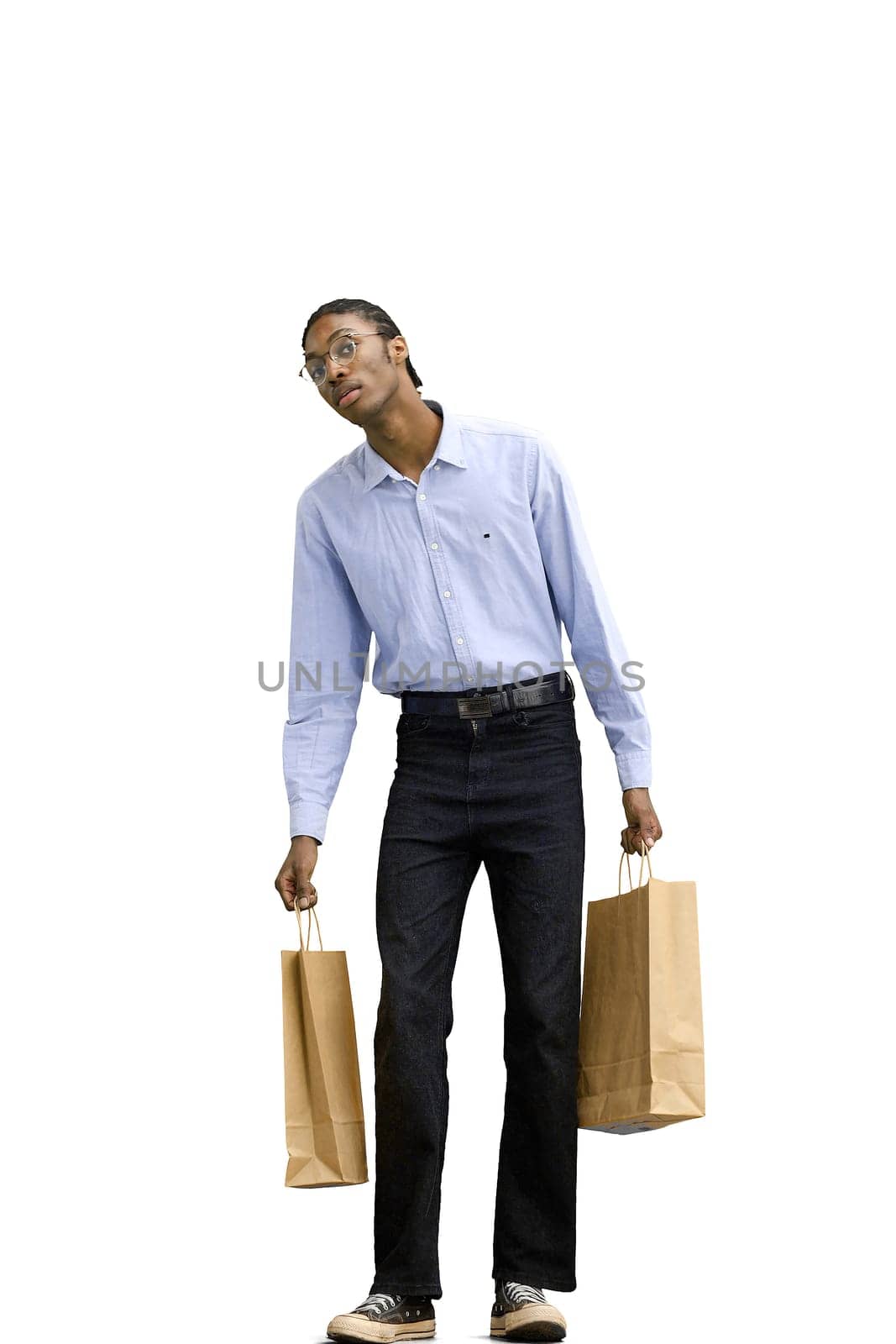 A man in a gray shirt, on a white background, full-length, with bags.