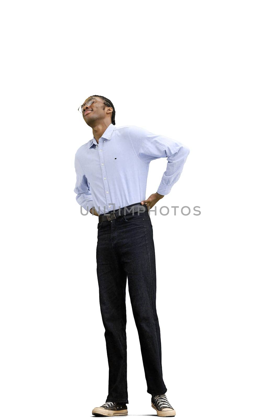 A man in a gray shirt, on a white background, full-length, back pain.