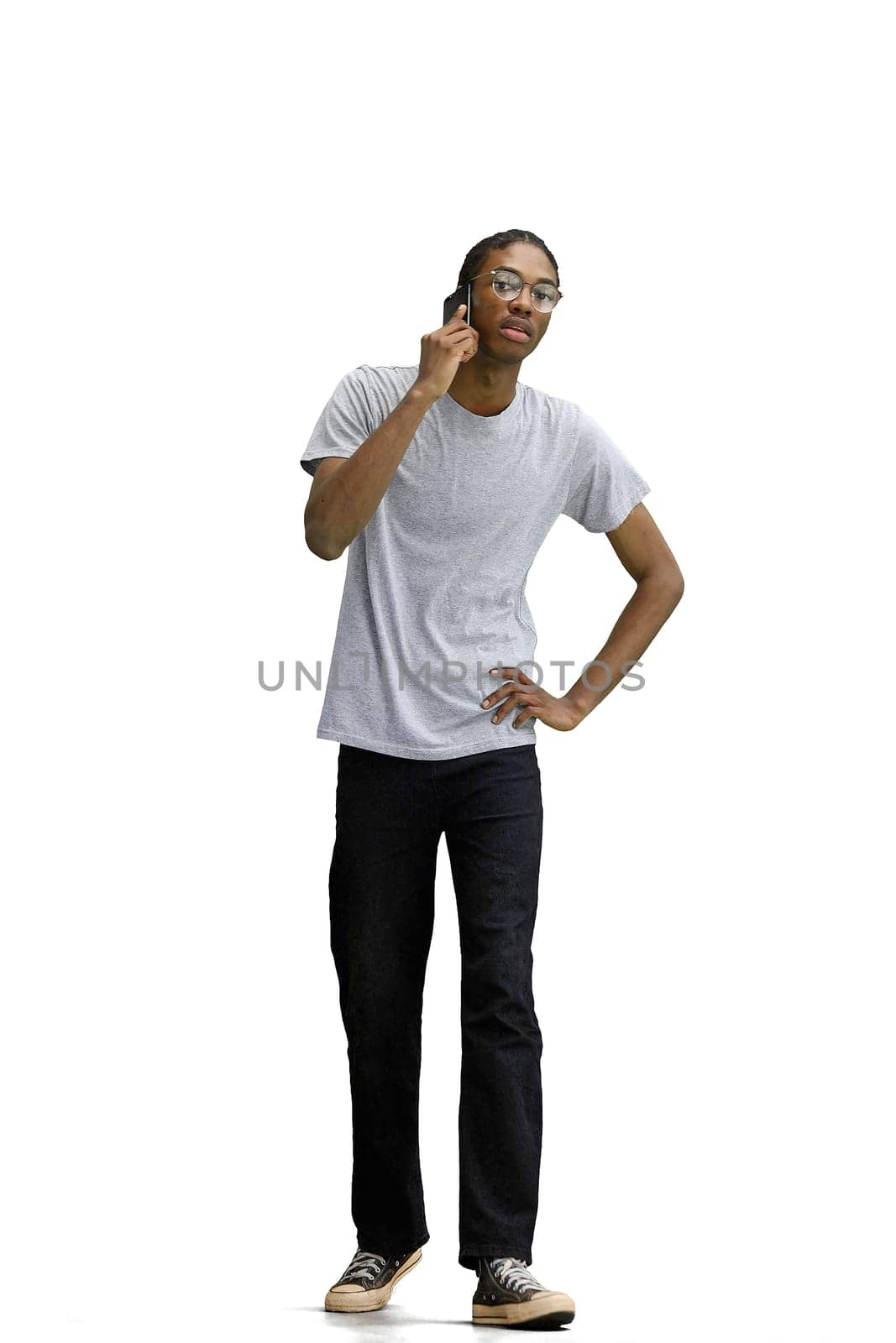 A man in a gray T-shirt, on a white background, with a phone by Prosto