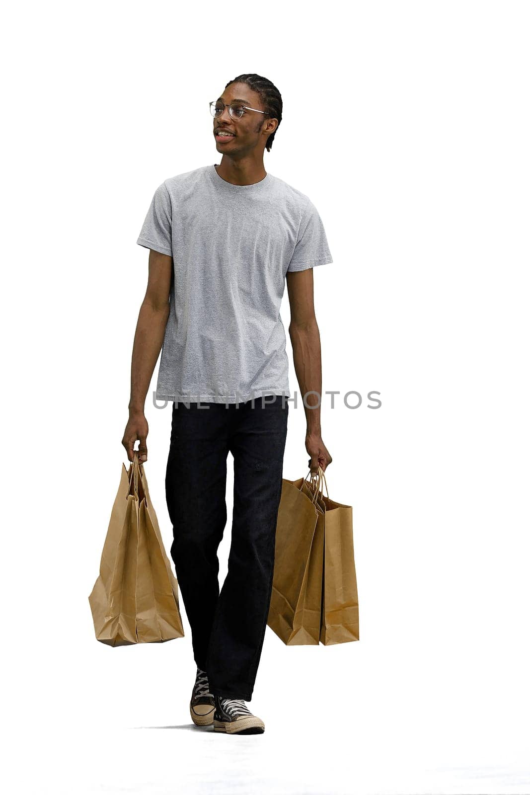 A man in a gray T-shirt, on a white background, with bags by Prosto