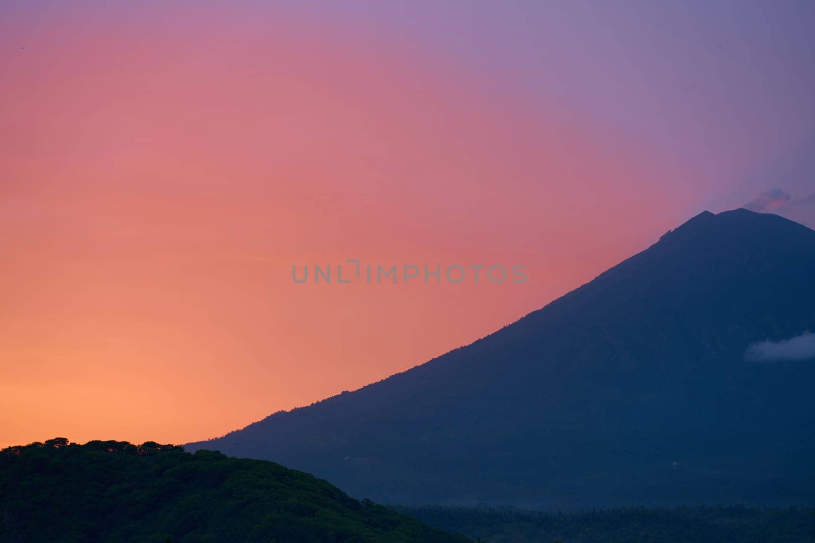 Silhouette of the Agung volcano at sunset. Panorama of the mountain on the island of Bali