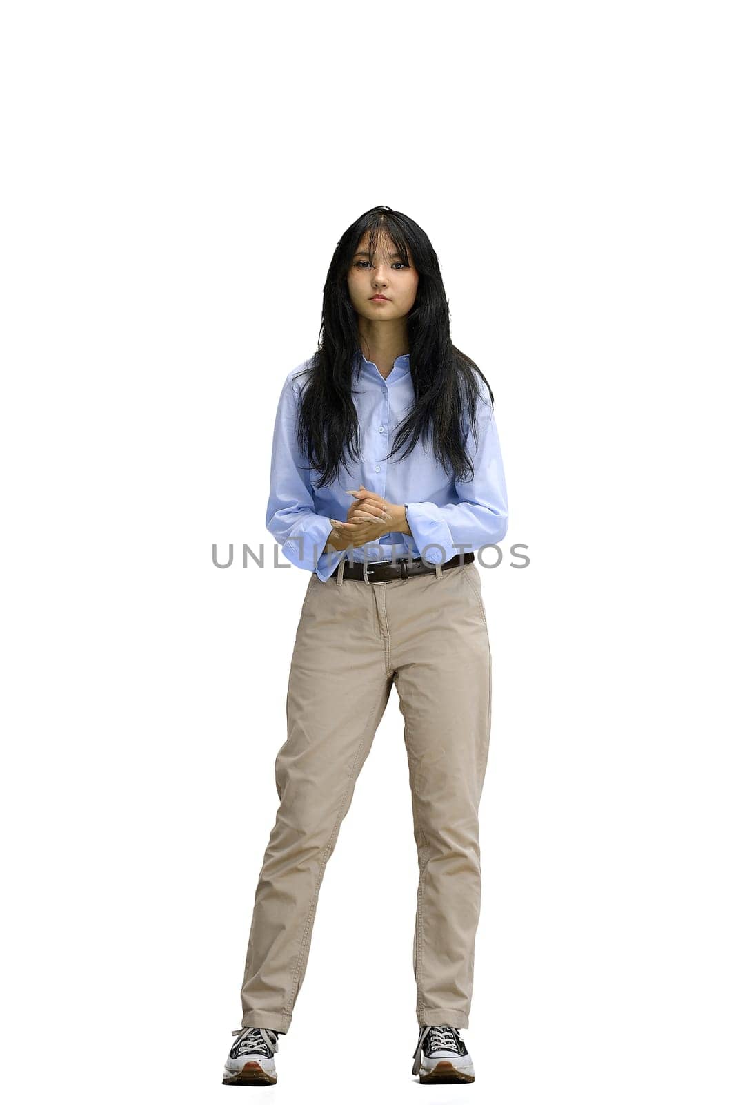 A girl in a blue shirt, on a white background, full-length.