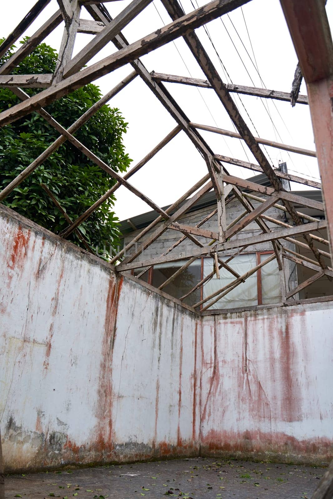 Walls from an abandoned old ruined house without a roof after a catastrophe