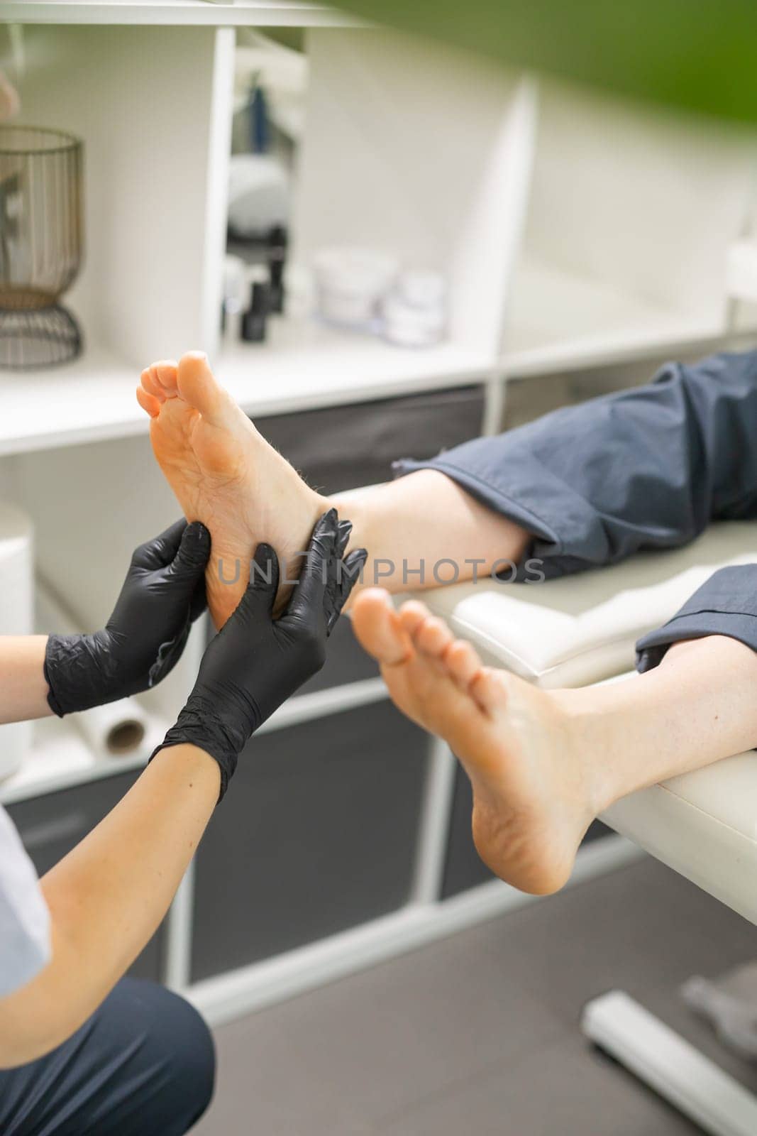 Woman doing foot peeling in pedicure SPA salon. Sugar scrub and relax beauty procedure by Satura86