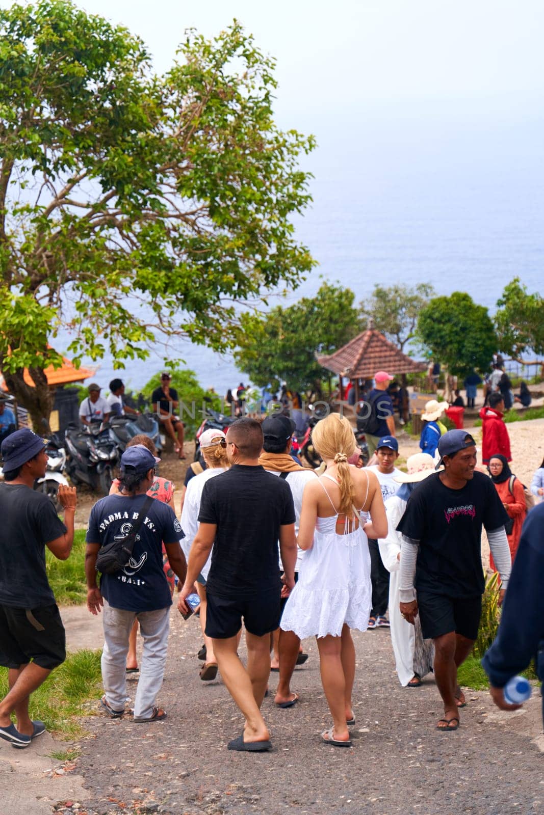 A crowd of tourists visits a popular place on an island in Indonesia. by Try_my_best