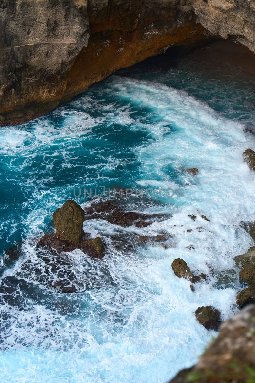 Cinematic aerial landscape shots of the beautiful island of Nusa Penida. Huge cliffs by the shoreline and hidden dream beaches with clear water and foaming wave