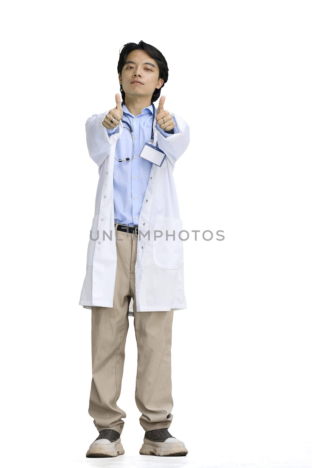 The doctor guy, on a white background, in full height, shows his thumbs up.