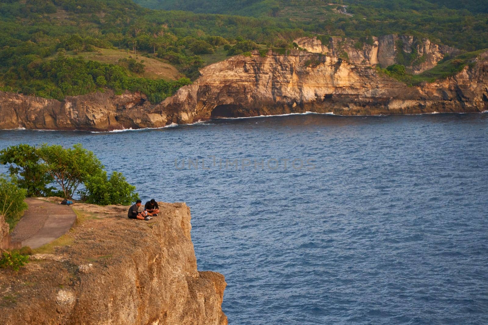 Cinematic aerial landscape shots of the beautiful island of Nusa Penida. Huge cliffs by the shoreline and hidden dream beaches with clear water and foaming wave