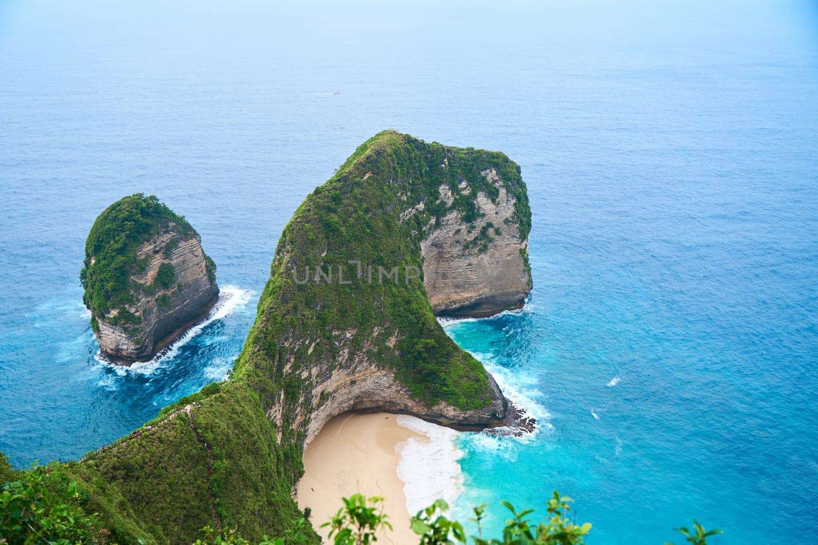 Cinematic aerial landscape shots of the beautiful island dinosaur of Nusa Penida. Huge cliffs by the shoreline and hidden dream beaches with clear water