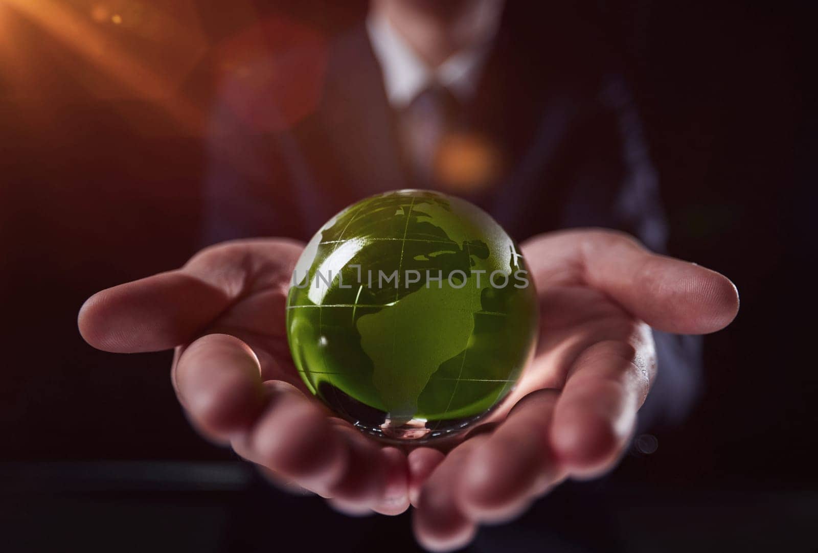 man holding a small green glass ball, generative ai by Prosto