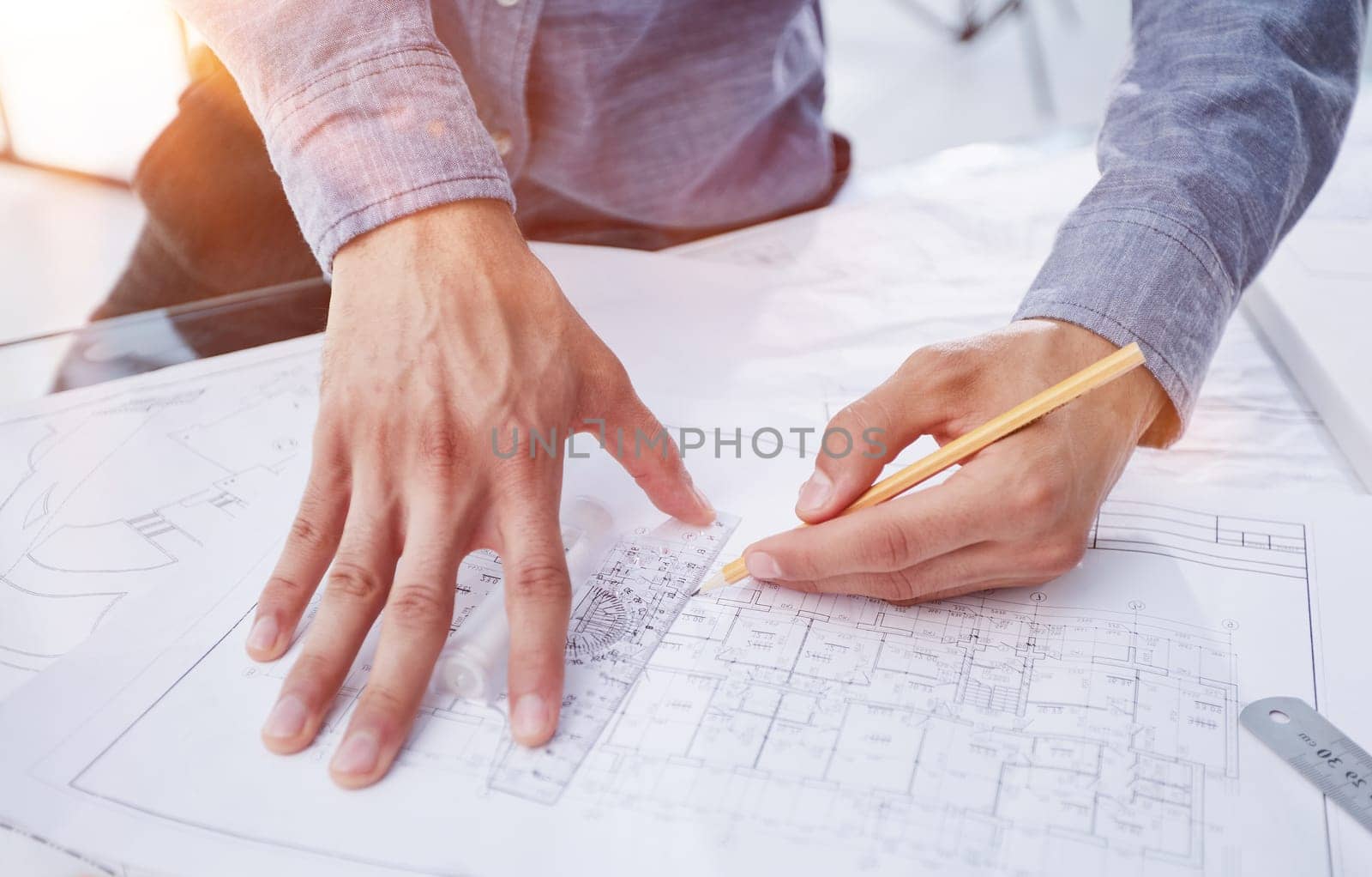 Architect engineer contractor design working drawing sketch plan blueprint and making architectural construction house building in architect studio.