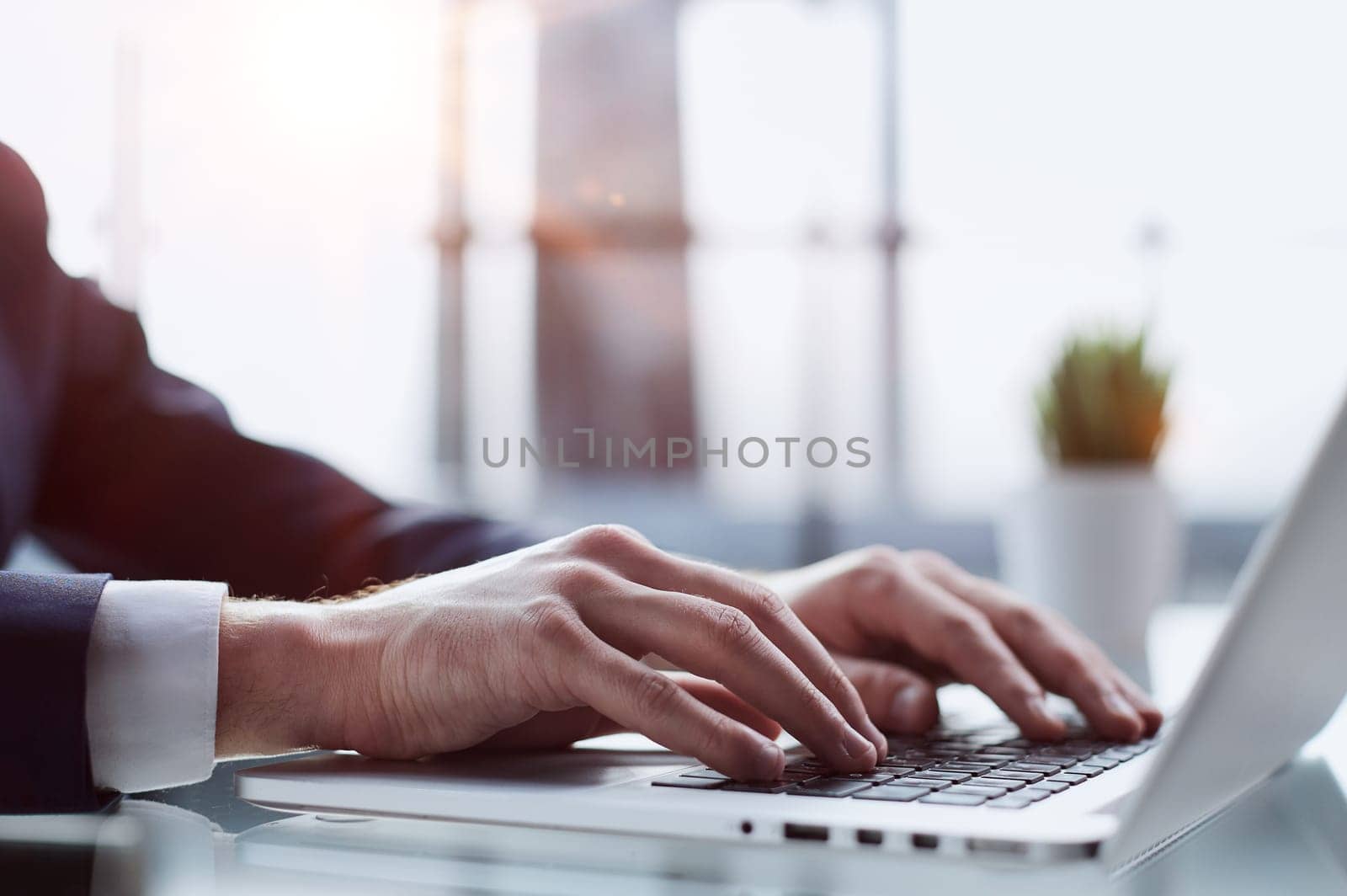 Closeup image of a man working and typing on laptop computer keyboard by Prosto