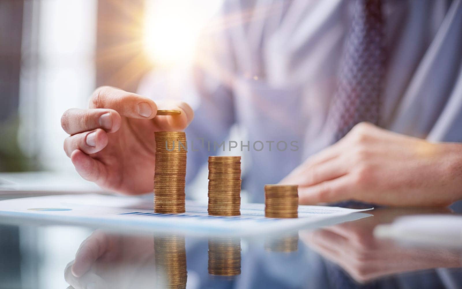 Business, Money, Finance, Secure and Saving Concept. Close up of man hand holding and put a coin to stack of coins table.