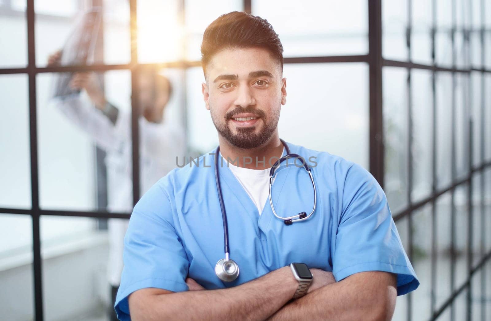 Portrait of confident male doctor standing in hospital lobby